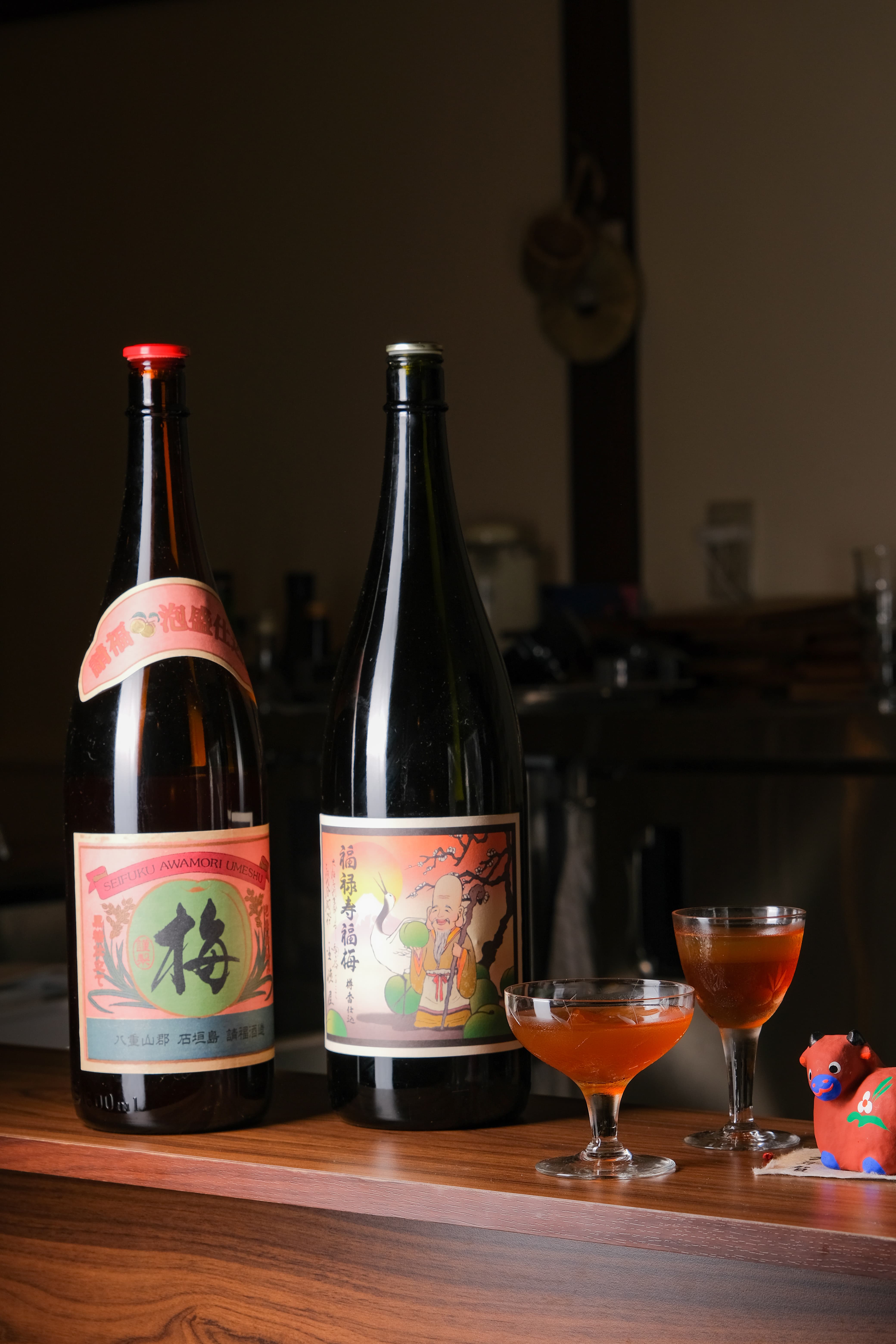 以琉球燒酎泡盛為基底的「請福梅酒」（左），淡淡黑糖香氣述說著日本南島風味。「福祿壽福梅酒」（右）帶有濃厚的白蘭地甘飴。（兩款皆為230元／杯）