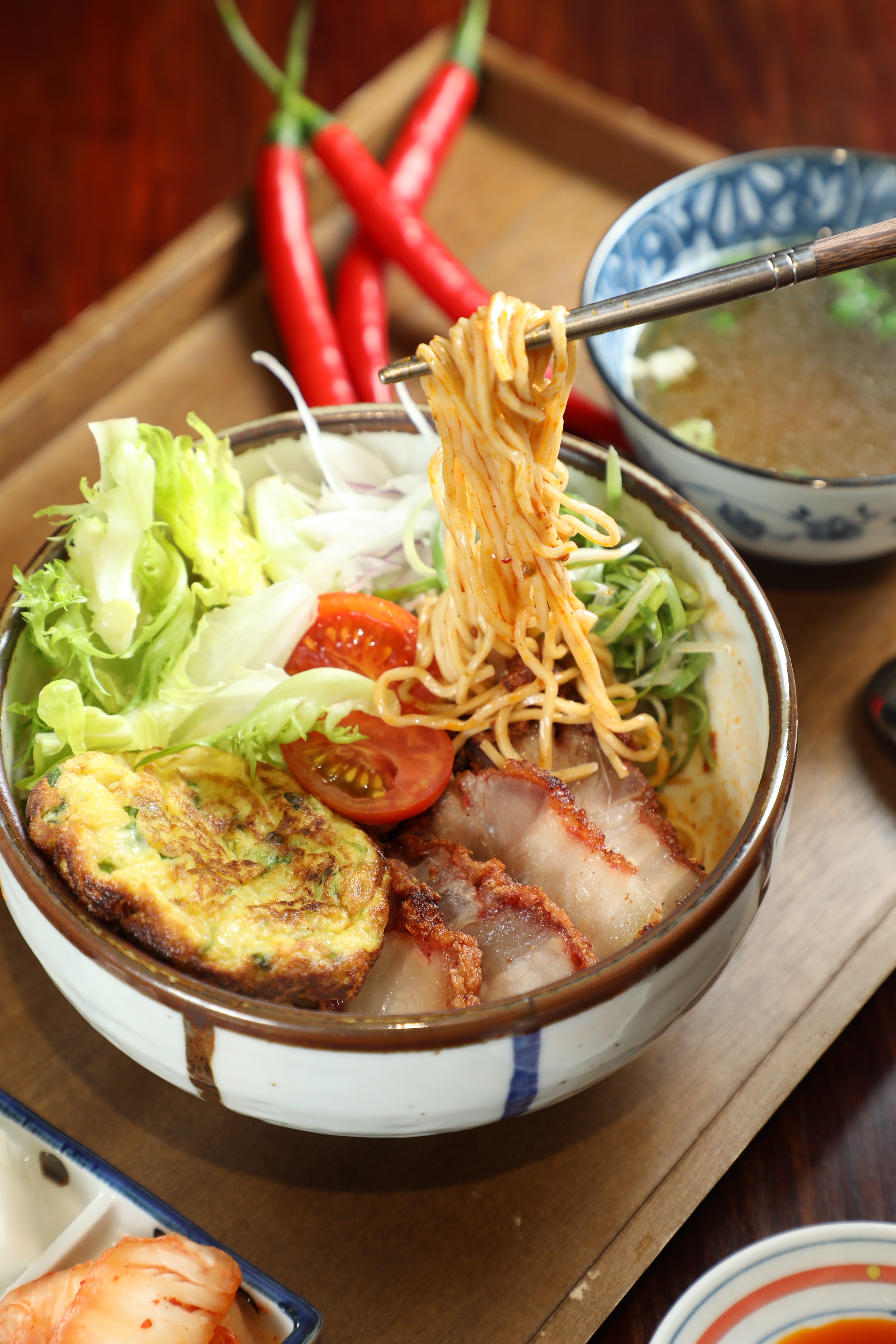 「香酥紅燒豚肉麻辣拌麵套餐」用十來種辛香料炒麻辣醬，裹著蔥蛋和紅糟肉相當過癮。（250元／套）