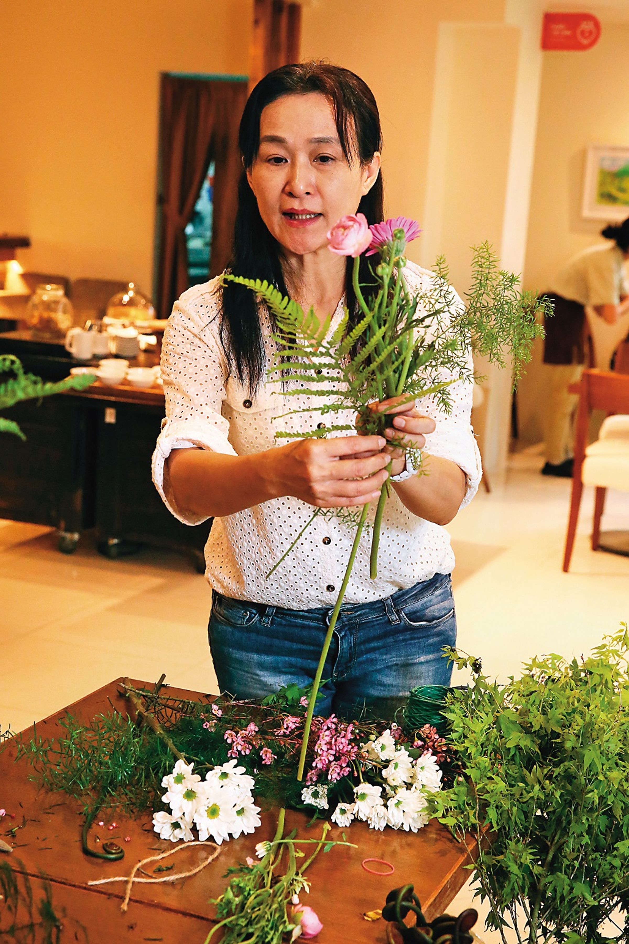 有30年花藝經驗的施妙宜老師，教導學員如何巧妙安排花材位置。