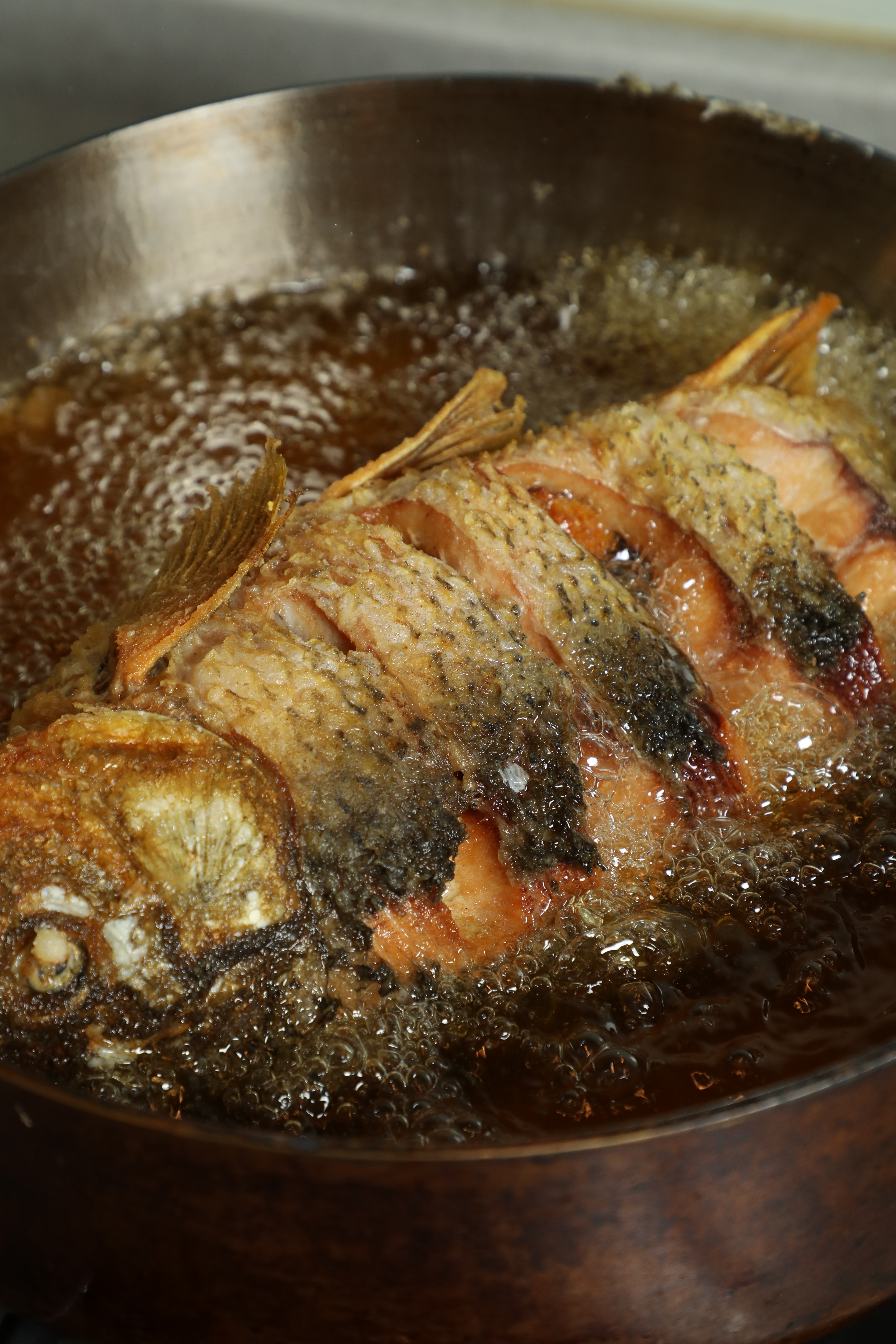 鯉魚炸至全尾金黃，即可撈起。
