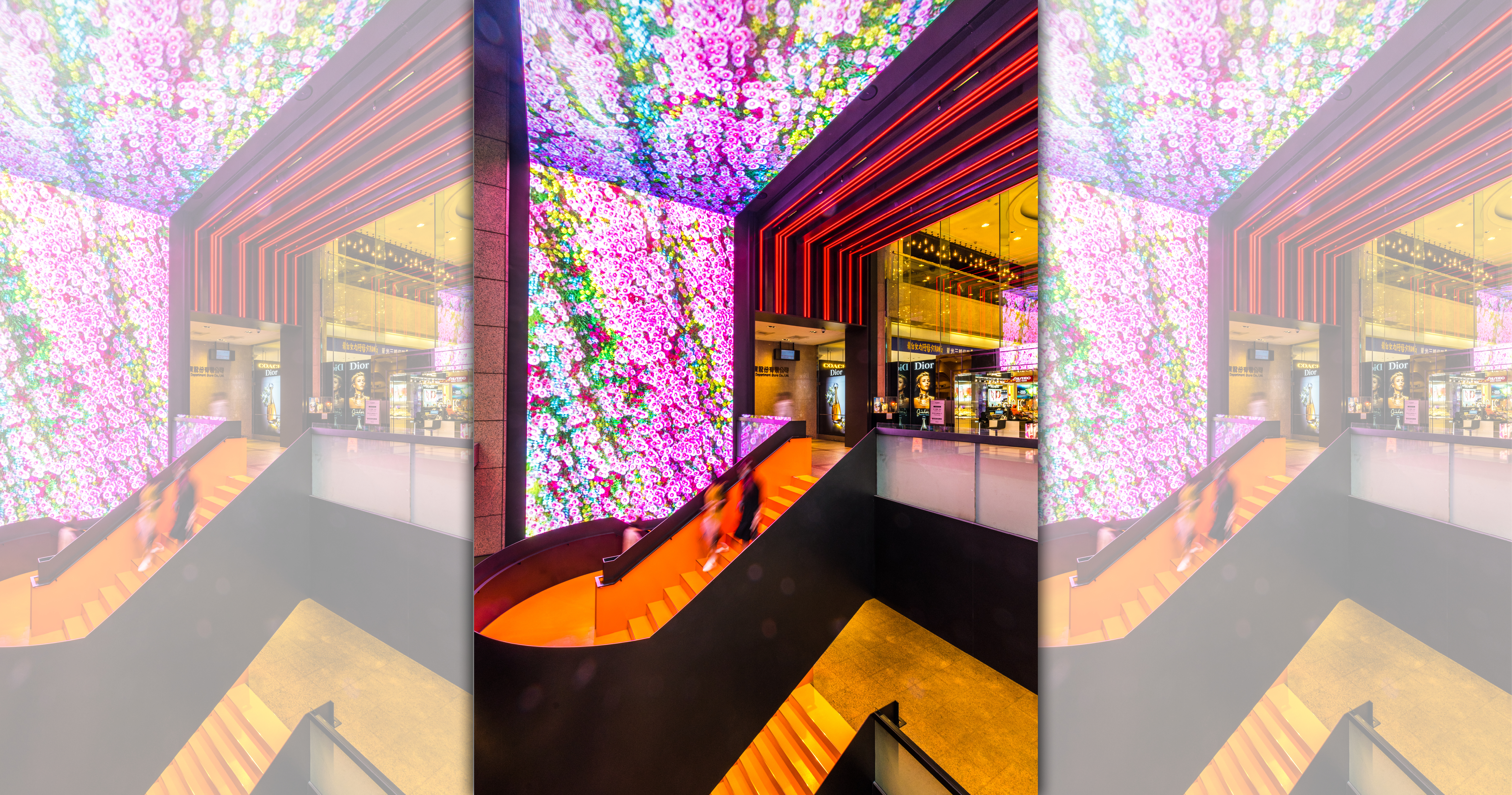 整個牆面延伸到天花板的螢幕，很難不吸引人注意。我好奇那個顏色的樓梯，走下去是不是愛馬仕的旗艦店？