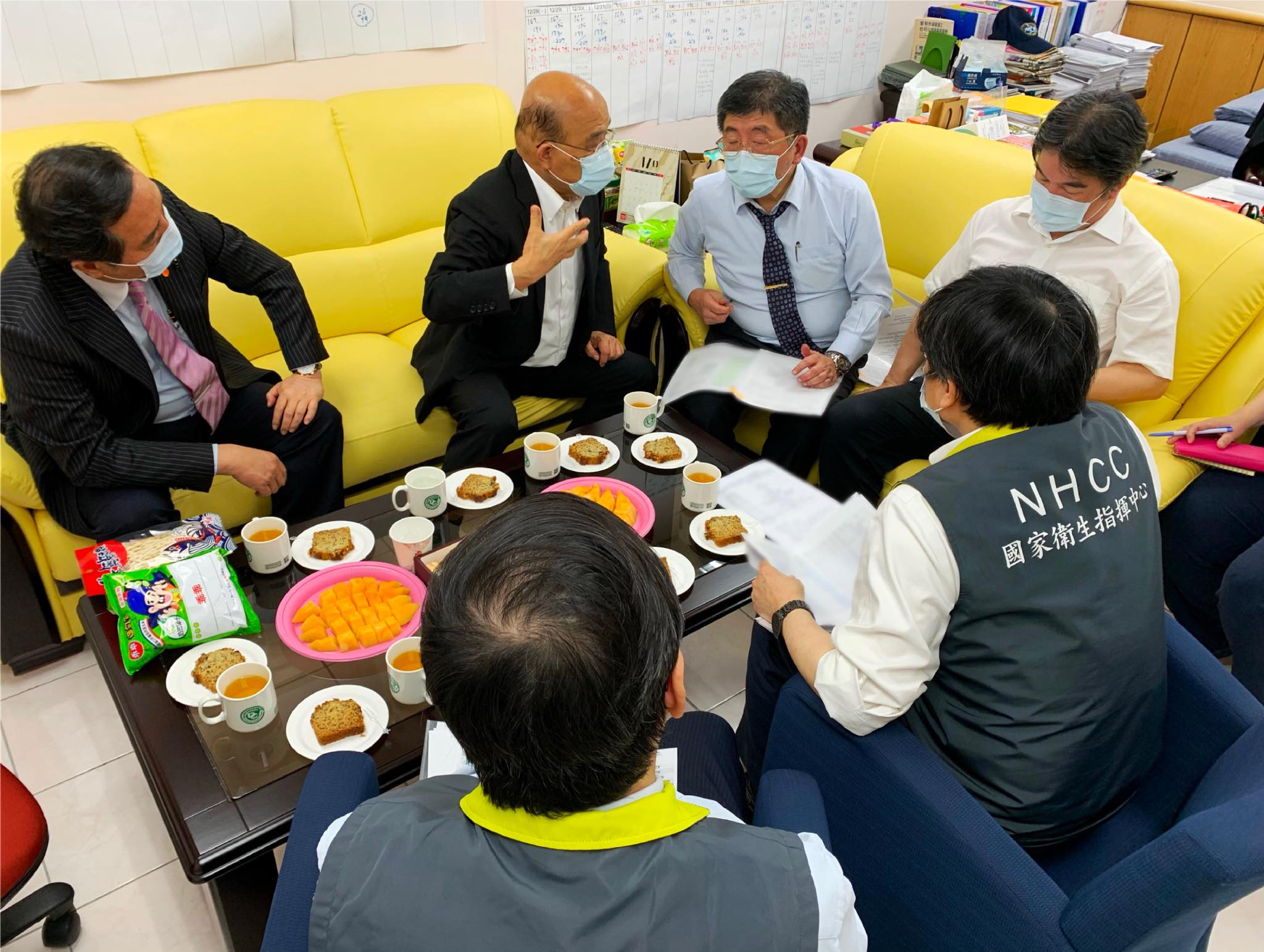 行政院長蘇貞昌（後排左2）昨晚赴指揮中心打氣，與指揮官陳時中（後排右2）等人一同商議防疫對策。（翻攝自蘇貞昌臉書）