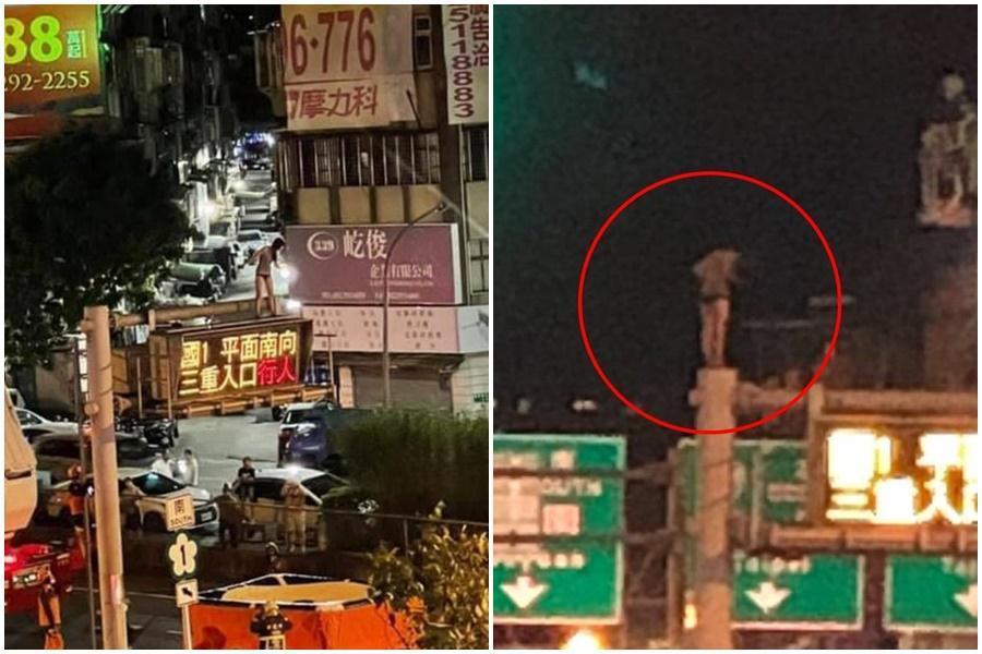 一名穿黑色激短熱褲妹，爬上車流較多的三重交流道口號誌燈柱上，引發大塞車。（翻攝自臉書爆料公社）