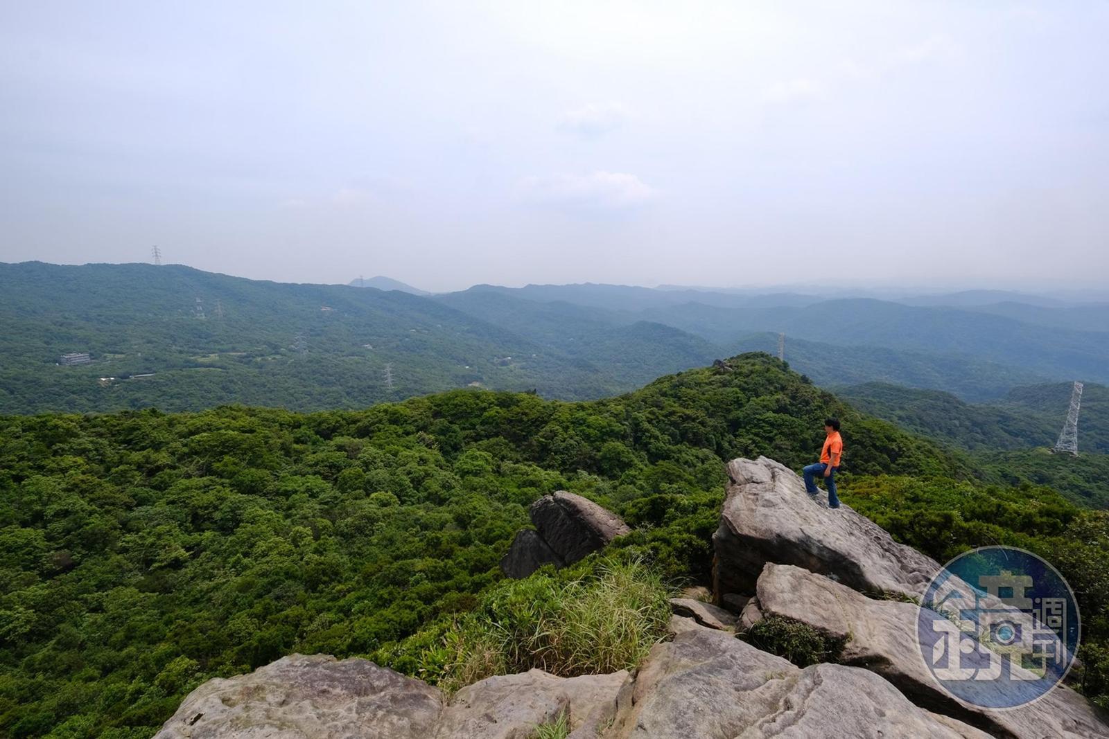 站在新山巨石上，可眺望五指山等山景。
