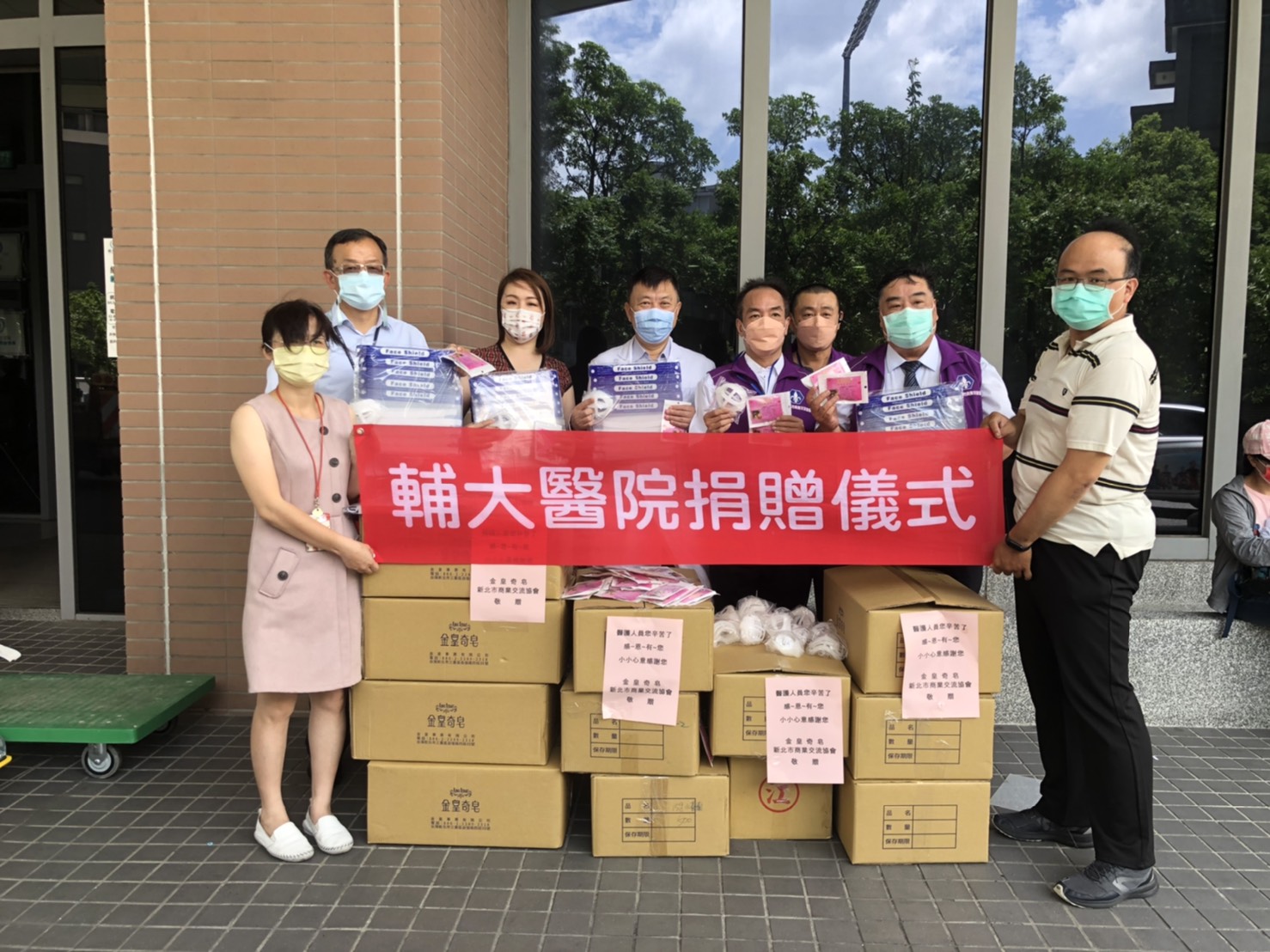 新北市議員劉美芳（後排左二）與商業協會、企業共同捐贈防護面罩、口罩和口罩支架上千個給輔大醫院。（劉美芳服務處提供）