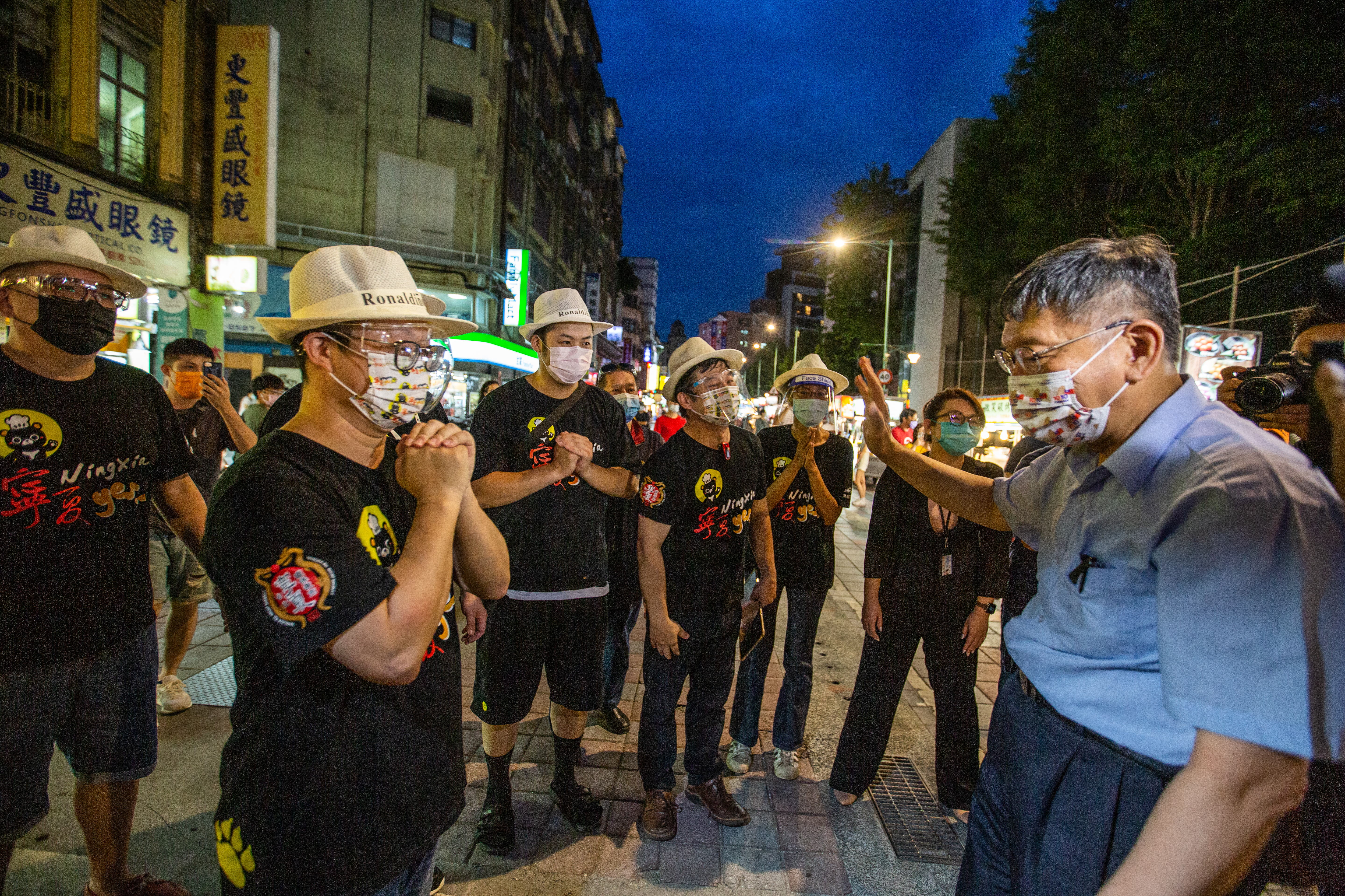 台北市長柯文哲（右）1日晚間親赴寧夏夜市視察「微解封」後的營業情形，為攤商鼓勵打氣。