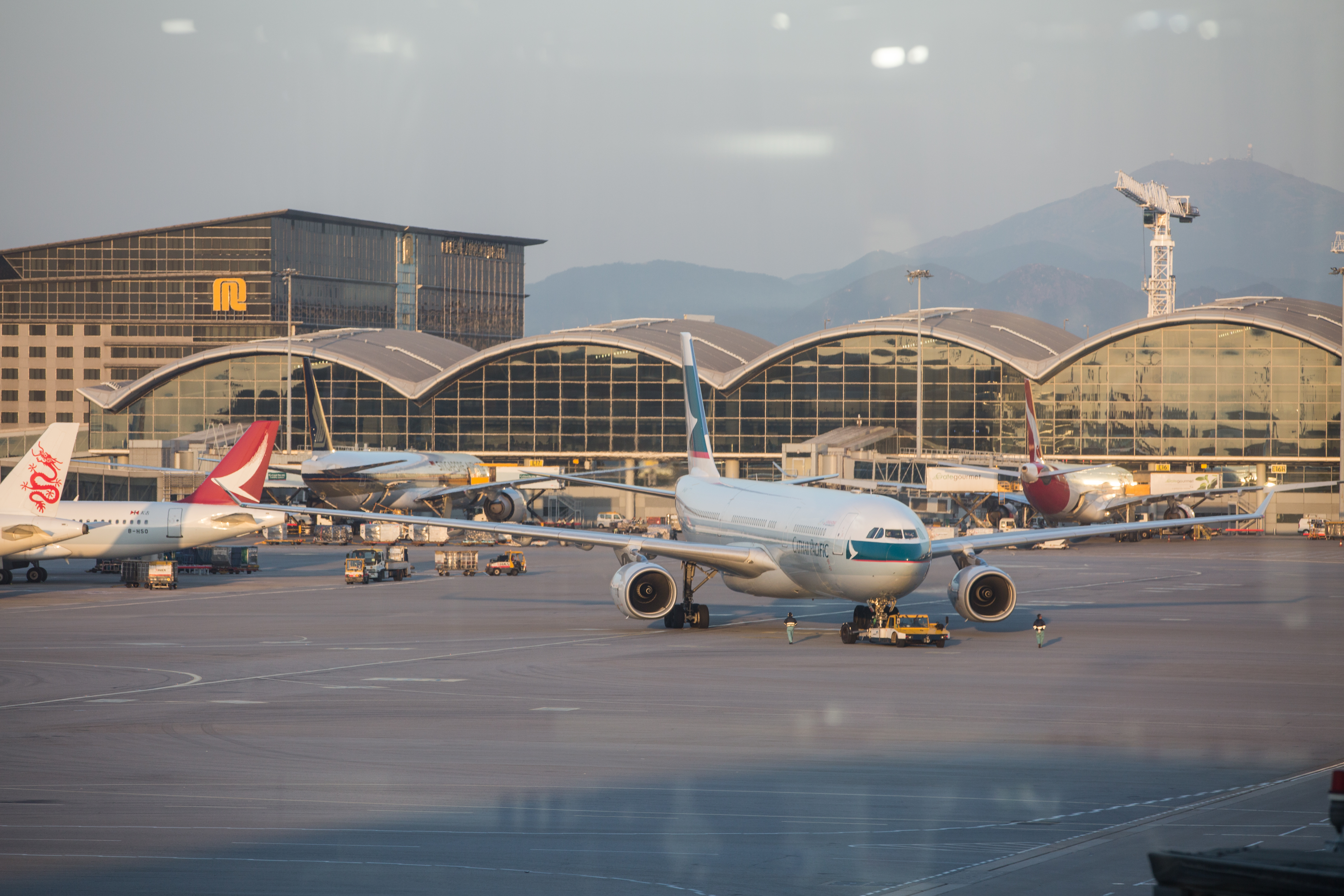 香港赤鱲角機場湧入近千人，不少家長帶著年幼子女，拖著數箱行李與親友道別。（本刊資料照）