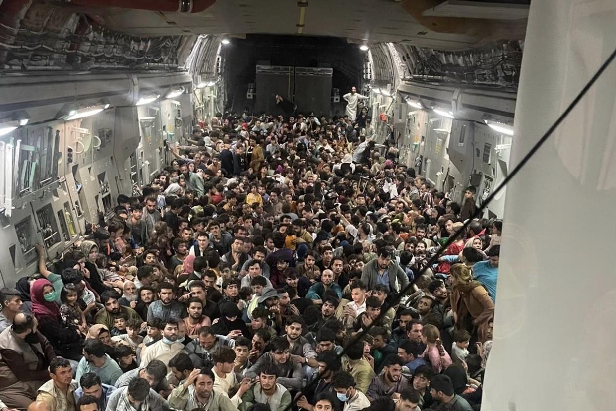 塔利班奪回阿富汗政權後,許多人為了活命擠進美國空軍C-17運輸機內。(翻攝@MarcusReports推特)