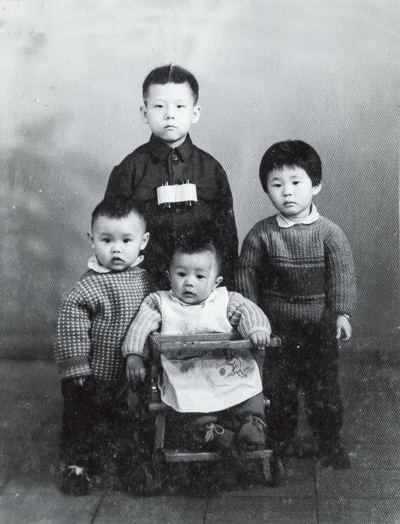 汪浩（後）5歲時與上海的表弟妹合照，照片背面有外公的手寫字跡。（蔡珠兒提供）