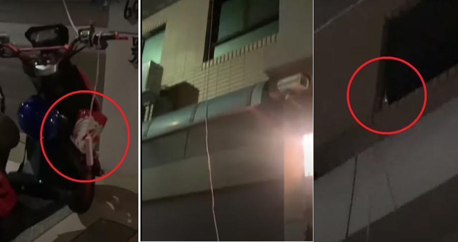 一名住戶從3樓自家窗戶拉到1樓停車場,為電動機車充電,危險舉動嚇壞居民。 (翻攝爆料公社)