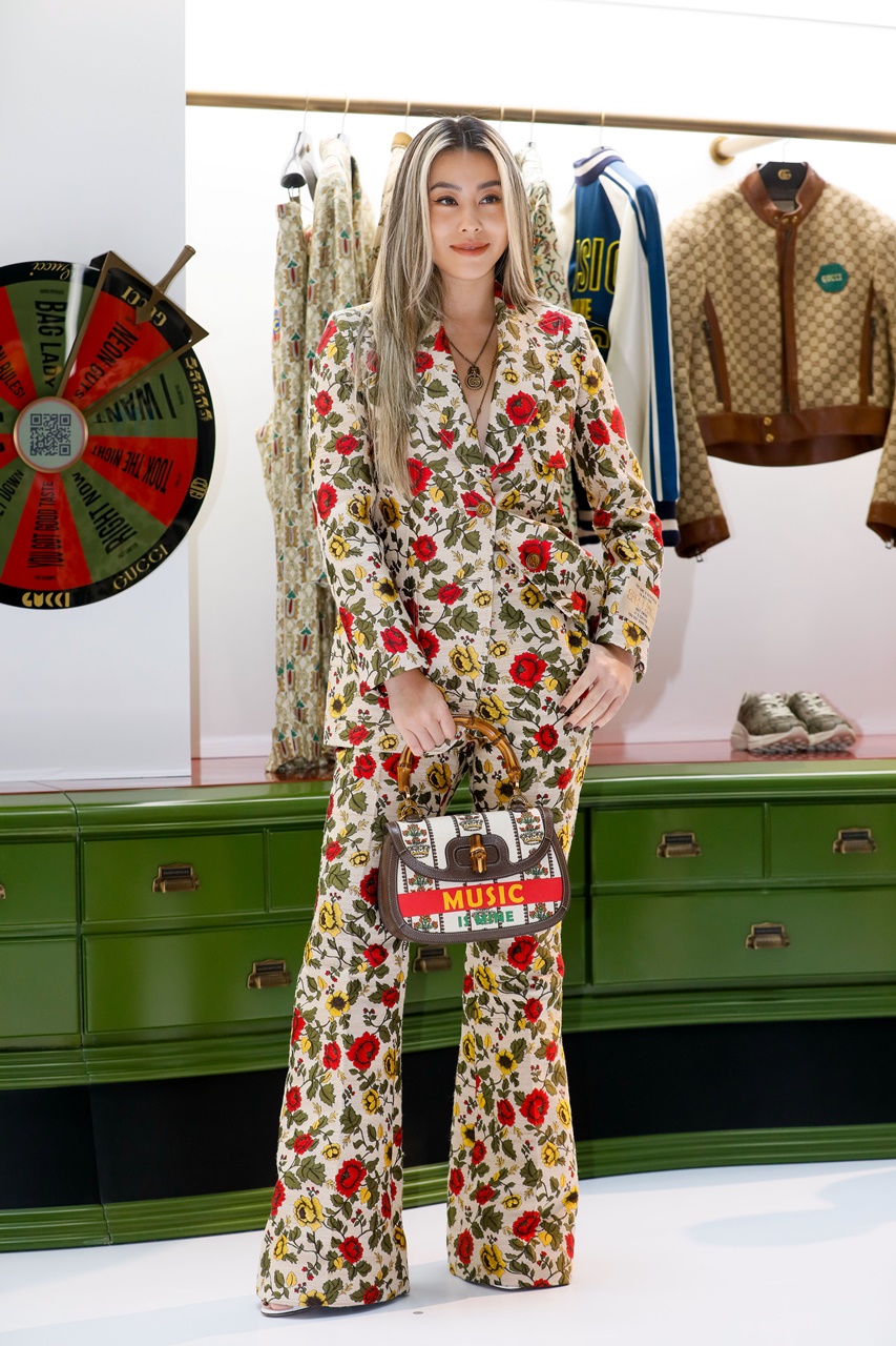 蔡詩芸穿著GUCCI多色花卉印花外套NT$130,000，多色花卉印花長褲NT$65,700，竹製提把手提包NT$119,000。