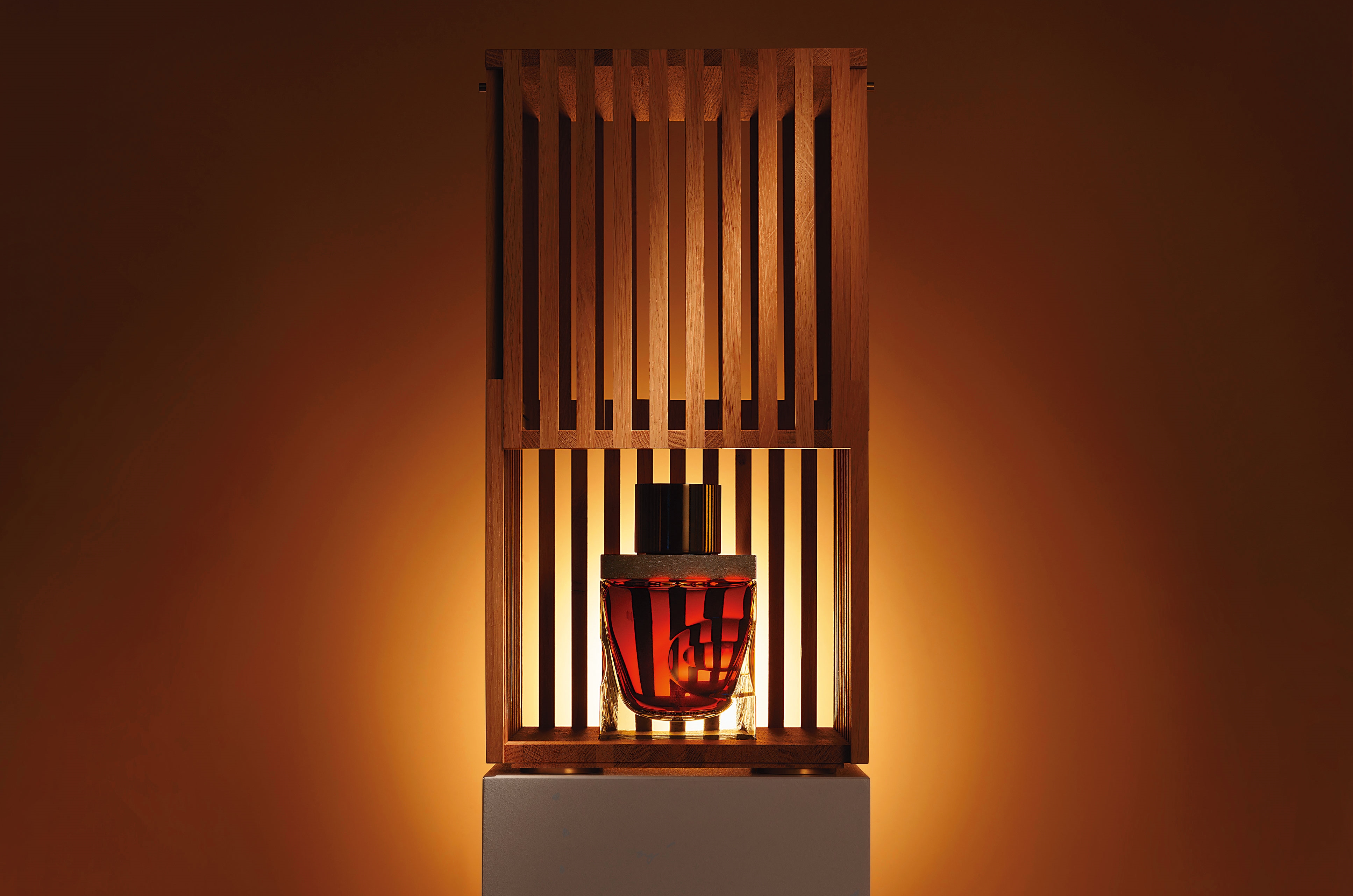 高登麥克菲爾裝瓶的格蘭利威80年，外盒的垂直木條呼應林中的橡木，木盒打開和關閉時，光與影的關係是關鍵設計，開關之間動作如同儀式般令人屏息。