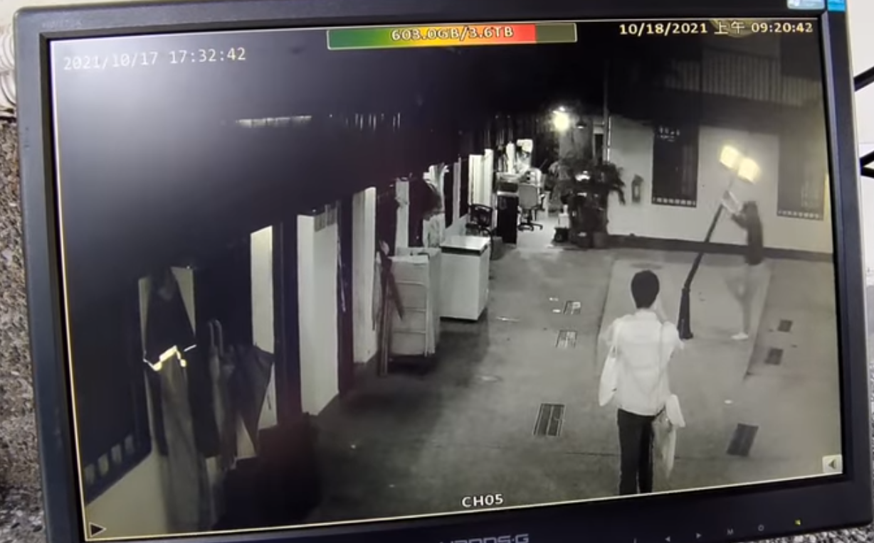 女子將路燈折斷後，一旁的男友趕緊上前協助。（翻攝自爆廢公社）