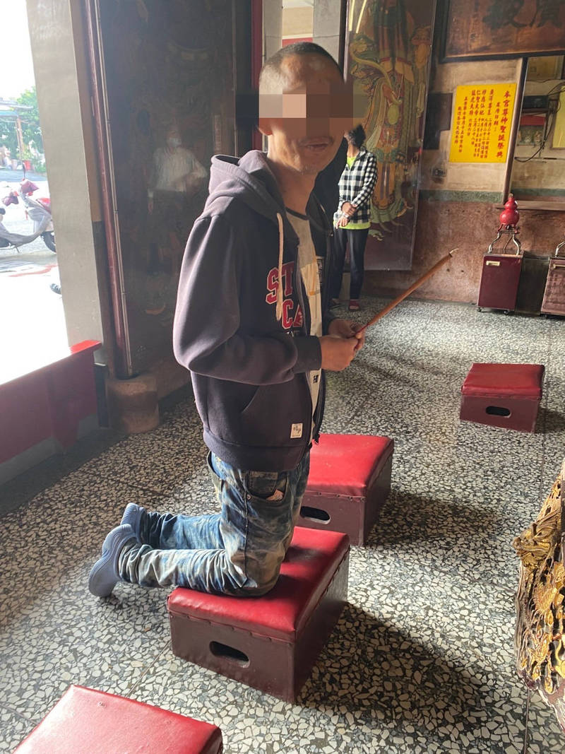 竊取神明銀牌的郭男拿香在神前跪拜懺悔，被警方逮個正著。（翻攝畫面）