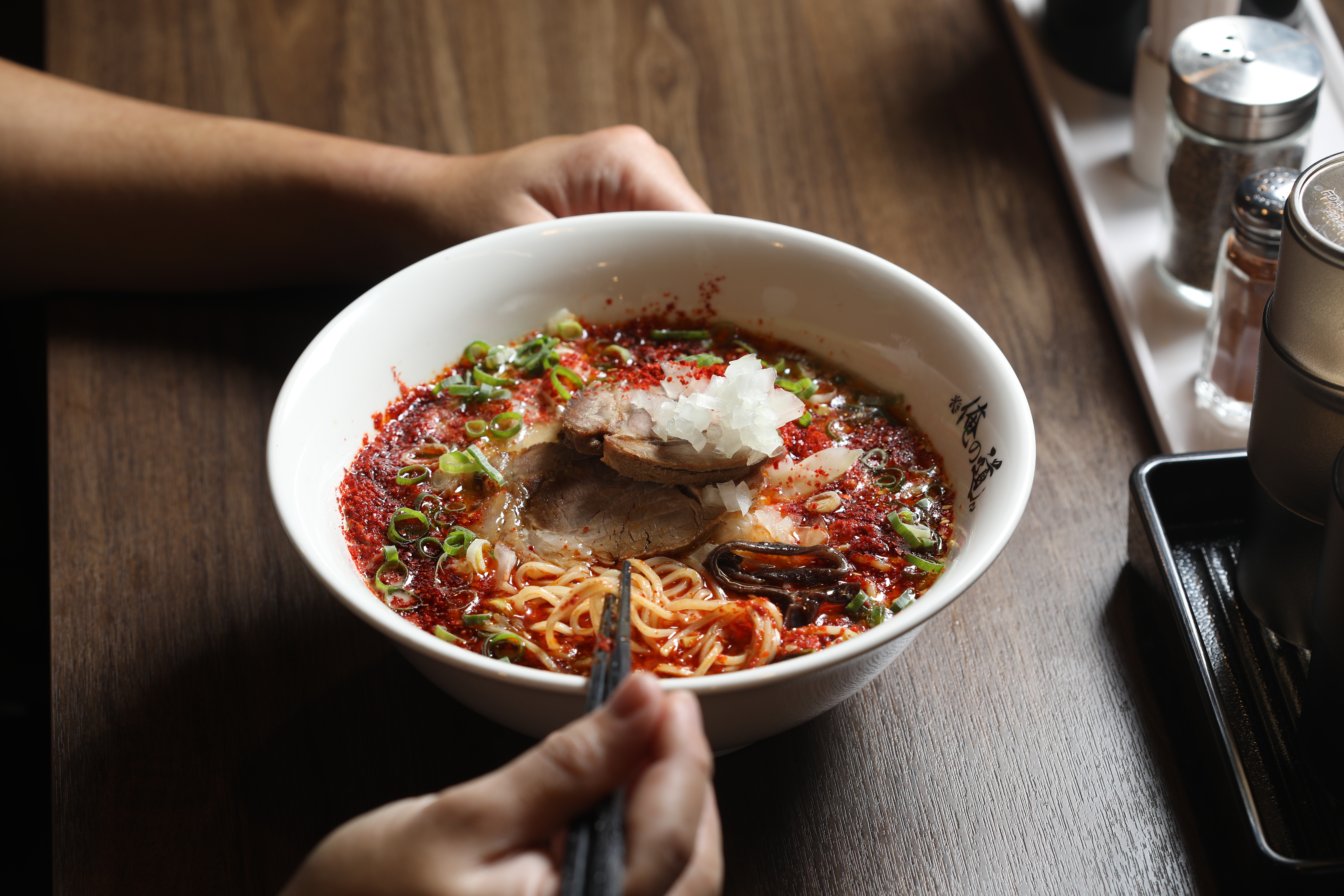 「辣味豚骨拉麵」撒滿粗粒辣椒粉增添視覺效果，點中辣以上會再加日本辣粉，吃來噴火過癮。（260元／碗）