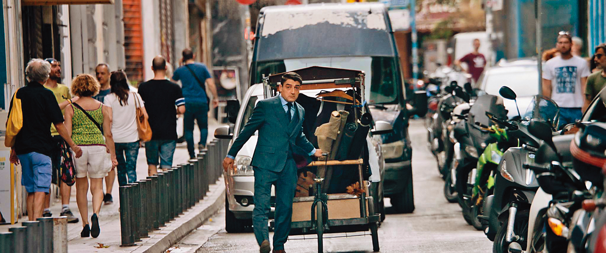 男主角的店舖遭銀行接收，他只能拉著小車，像流動攤販一樣在街頭賣起他的衣服。（天馬行空提供）