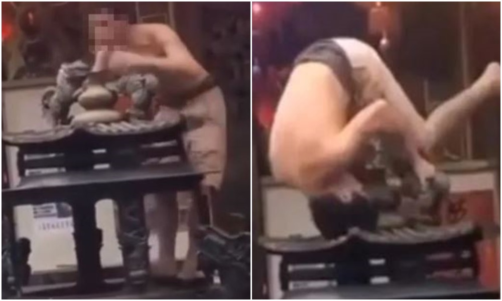 一名上身半裸的男子，直接爬上三芝福成宮的香爐倒立。（翻攝記者爆料網）