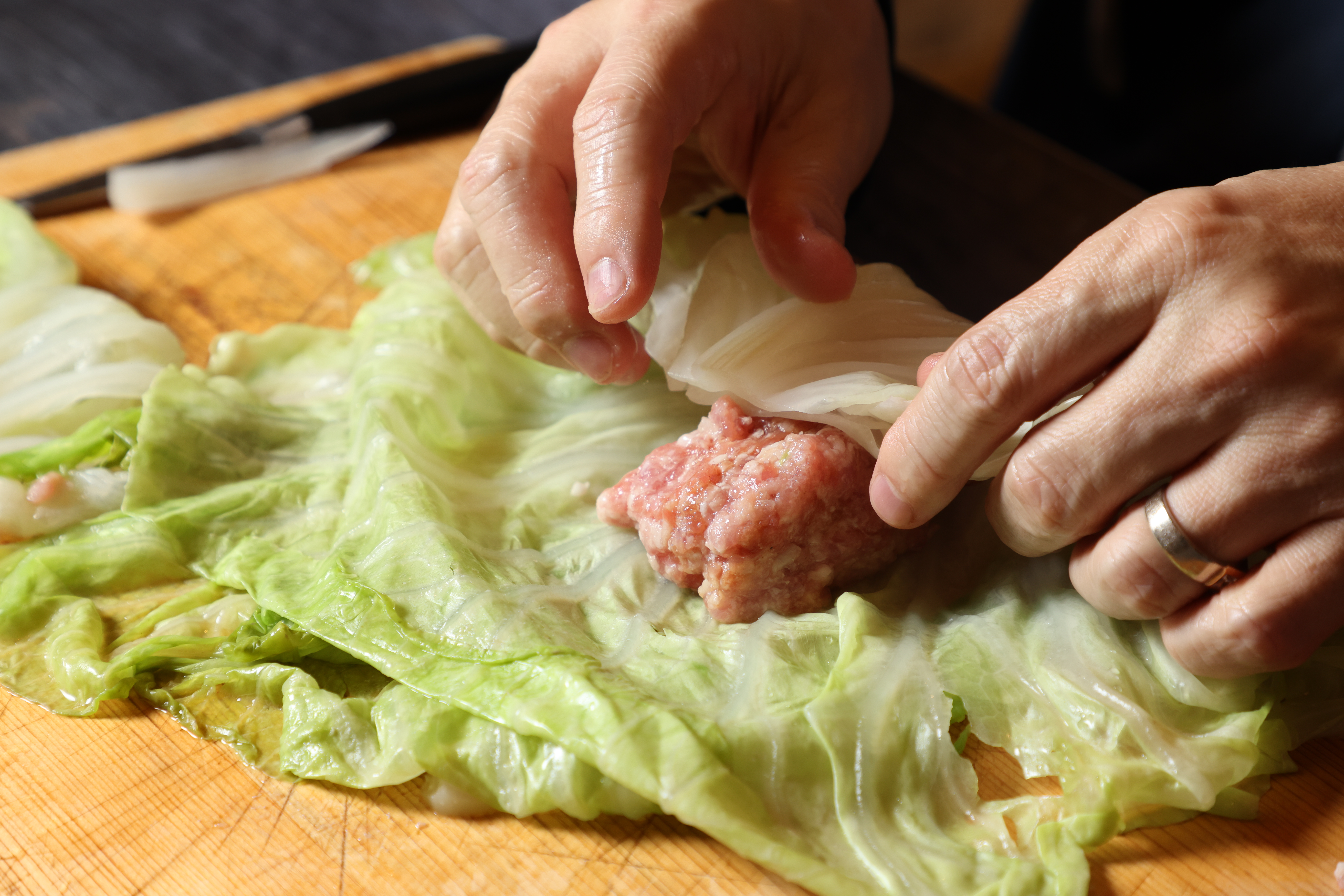 將絞肉放在2片高麗菜中，一邊折起。