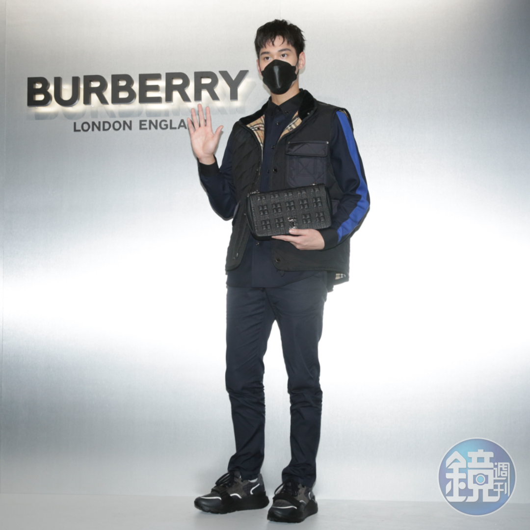 周予天身著BURBERRY絎縫溫度調節背心（NT$39,900）、修身工作褲（NT$18,200）、條紋羊毛襯衫（NT$22,900），手拿黑色中型絎縫羔羊皮Lola包（NT$79,000）。
