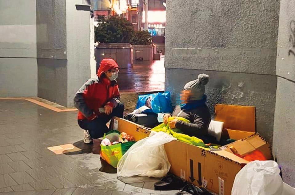 今年2月底，寒流來襲，張獻忠（左）在街頭發送暖暖包給無家者。他說：「這是基本sense，冬天來時就該先訂好（保暖物資）。」（張獻忠提供）