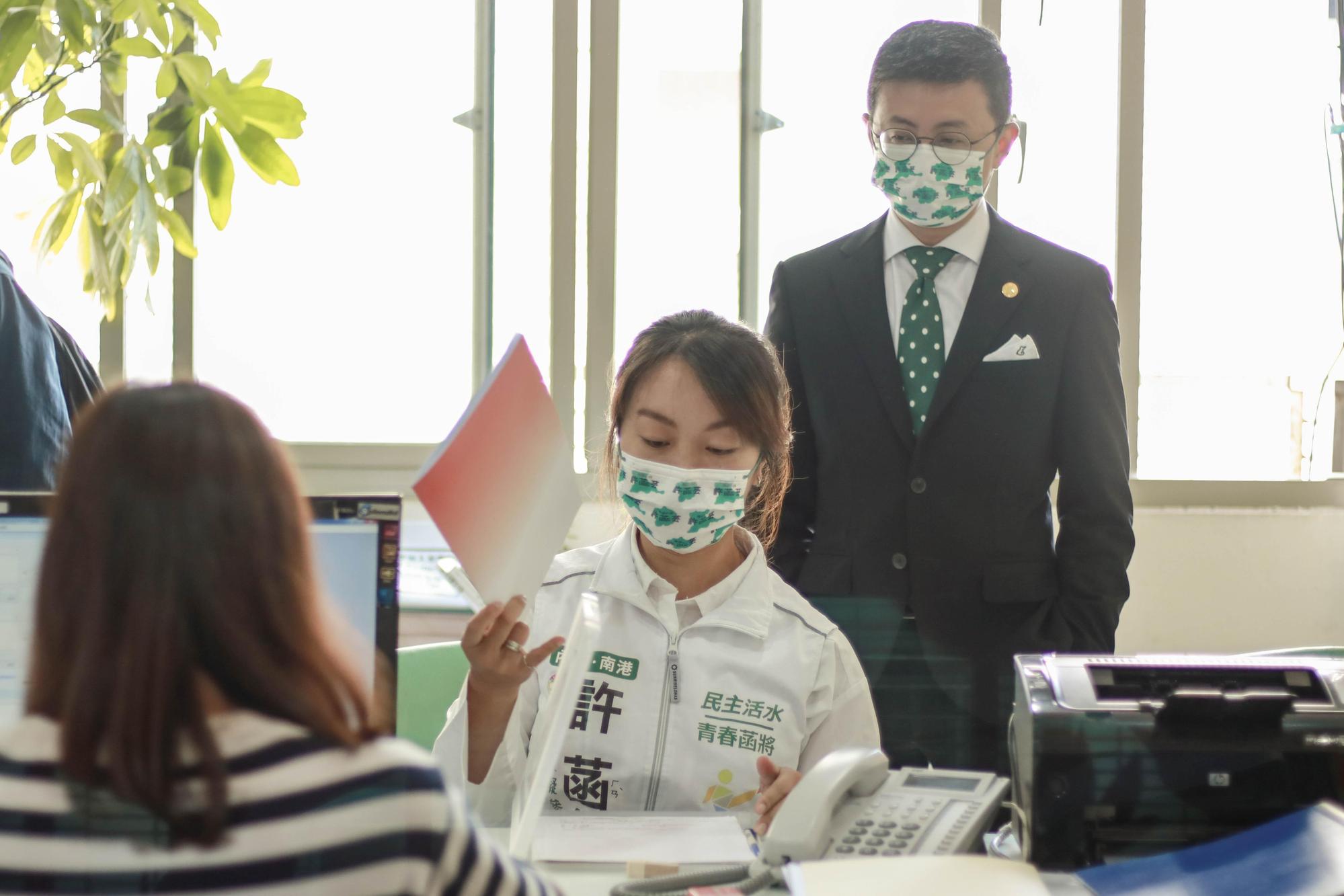 邱威傑(後)陪同自己的前辦公室主任許菡芸登記參加民進黨黨內初選。(謝孟羽提供)
