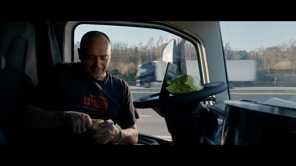 彼得多繹切夫在車上一邊削馬鈴薯準備煮食、一邊與家人手機視訊。（公視提供）