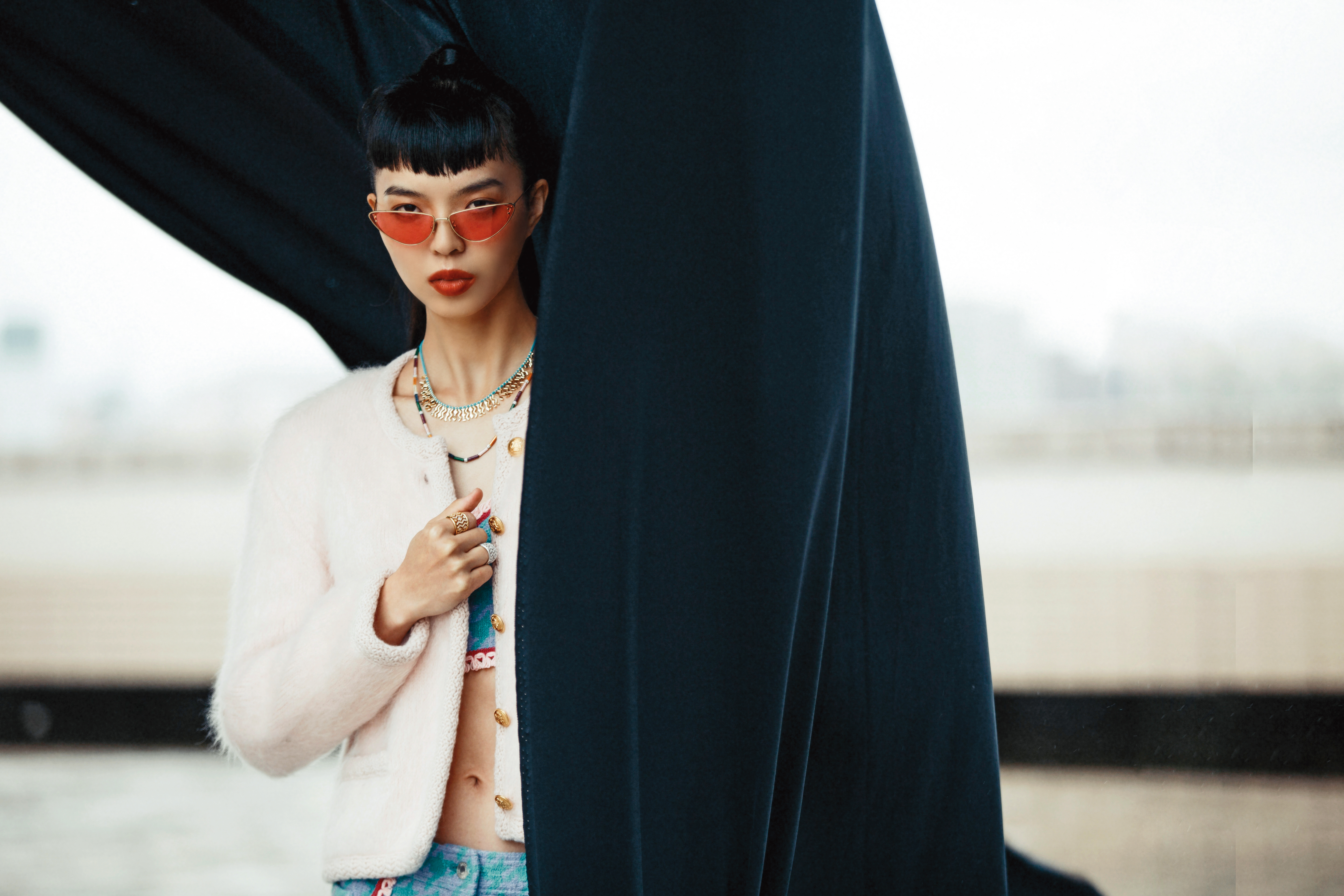 毛海排釦針織外套 NT$69,000 by CELINE，水藍色短版Bra NT$36,500 by MOSCHINO，水藍色西裝短褲 NT$33,800 by MOSCHINO，MissDior粉色太陽眼鏡 NT$14,300 by DIOR，Batik可調節尼龍項鍊（上） NT$11,400 by APM MONACO，彩虹微鑲可調節項鍊（下） NT$22,800 by APM MONACO，金色Batik戒指（上） NT$5,200 by APM MONACO，銀色Batik戒指（下） NT$4,800 by APM MONACO。