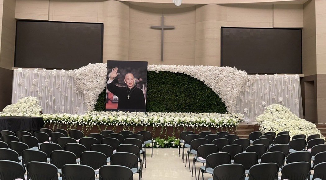 追思禮拜會場以白色鮮花布置,遺照則選用了王羽2011年入圍金馬男配獎,在紅毯揮手的照片。(家屬提供)