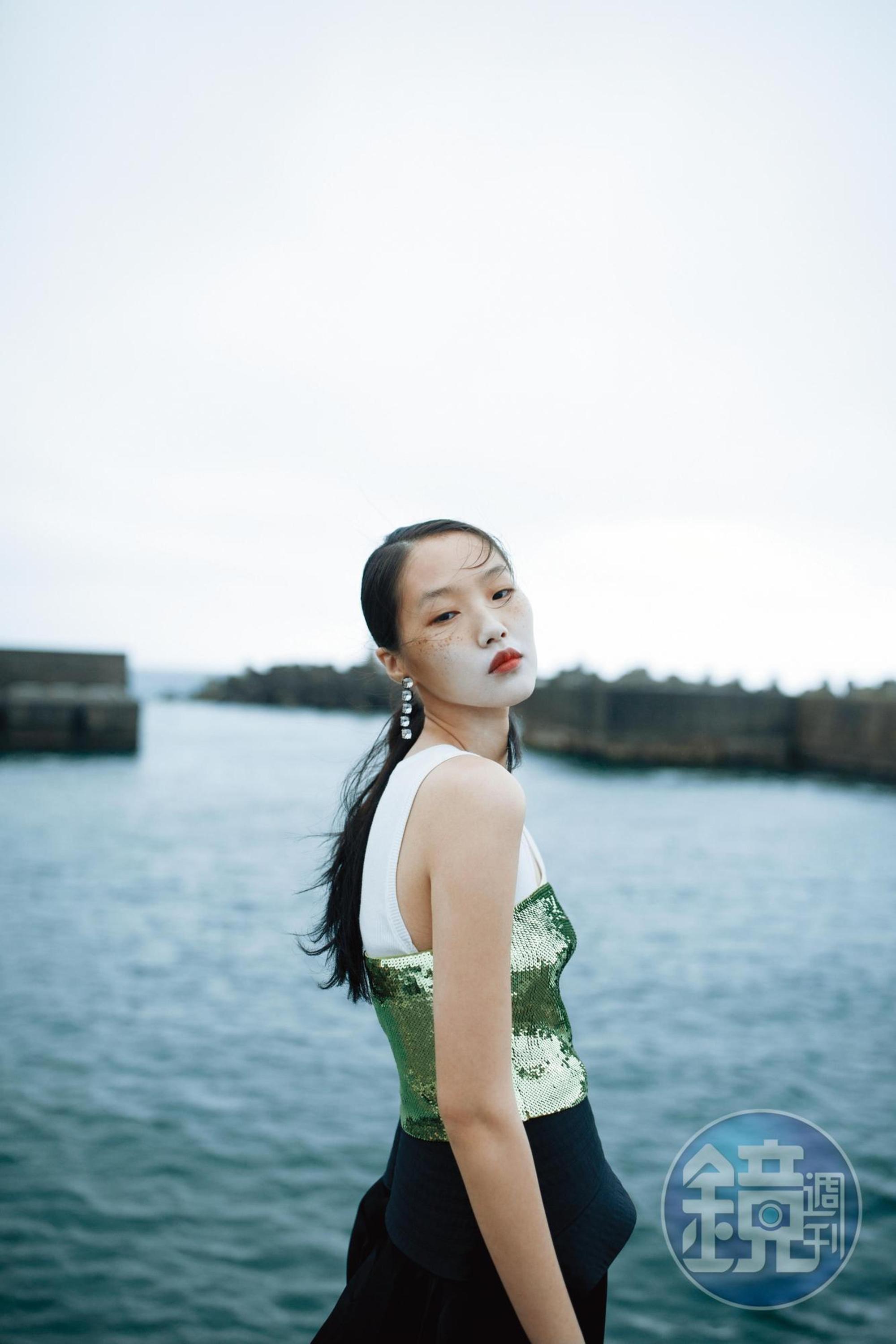 白色Anagram背心上衣 NT$12,000 by LOEWE；綠色亮片平口背心 NT$43,000 by LOEWE；黑色荷葉邊長褲 NT$79,000 by LOEWE；Harmonia水滴型耳環 NT$5,450 by SWAROVSKI。
