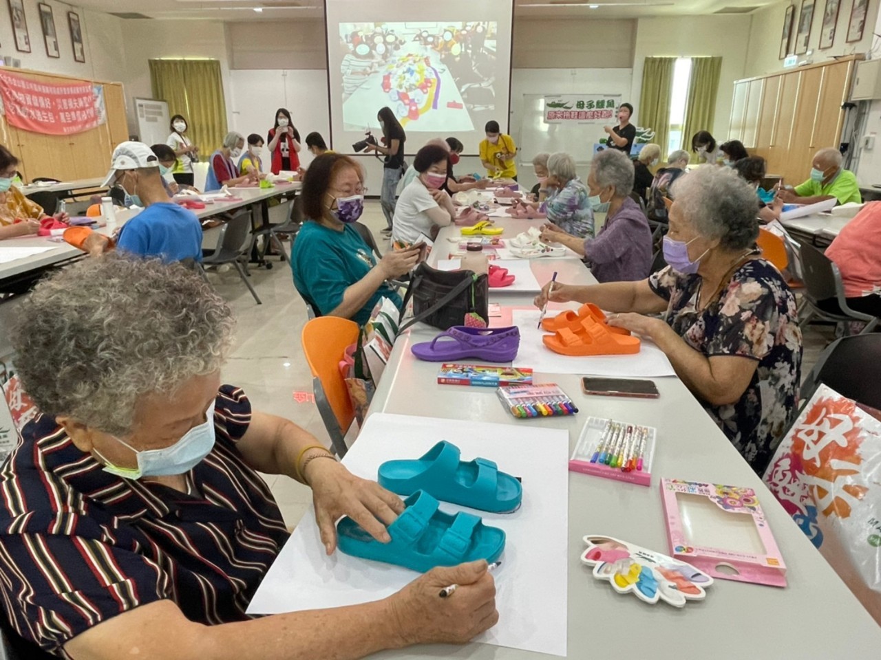 長輩們認真彩繪獨一無二的拖鞋。（金山區公所提供）