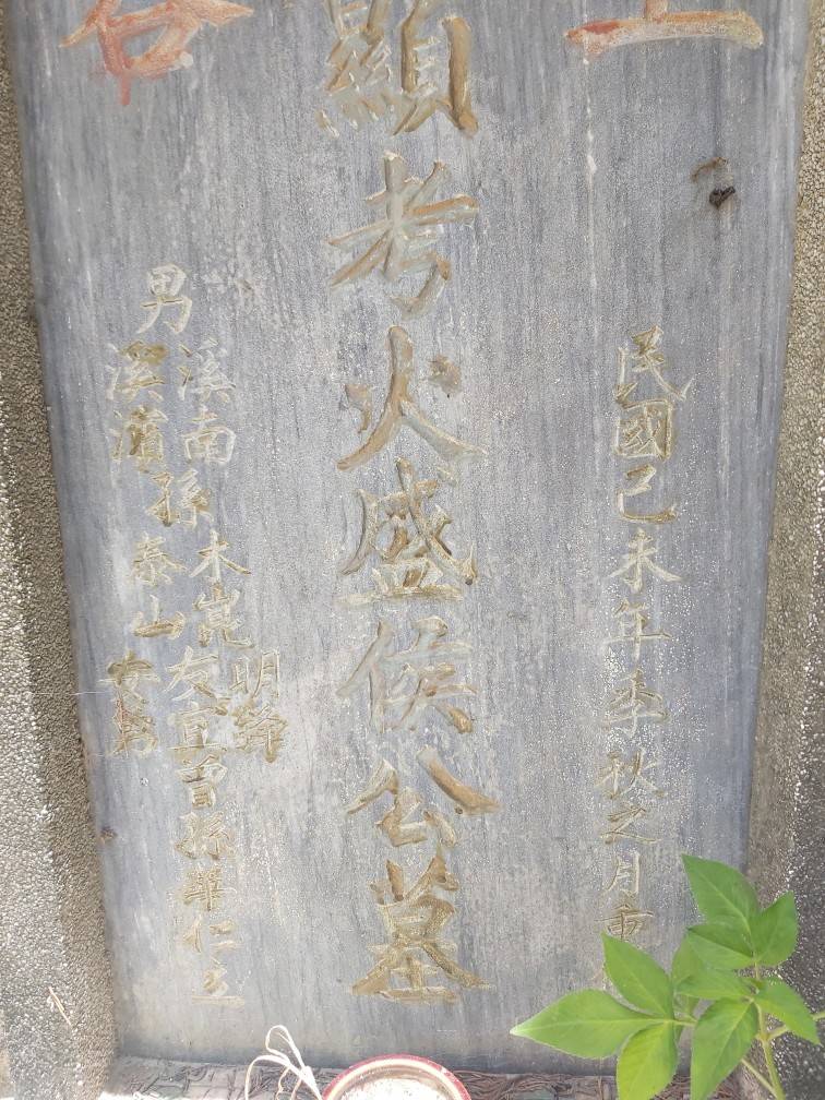 墓碑上刻有「明鋒」「友宜」字樣。(讀者提供)