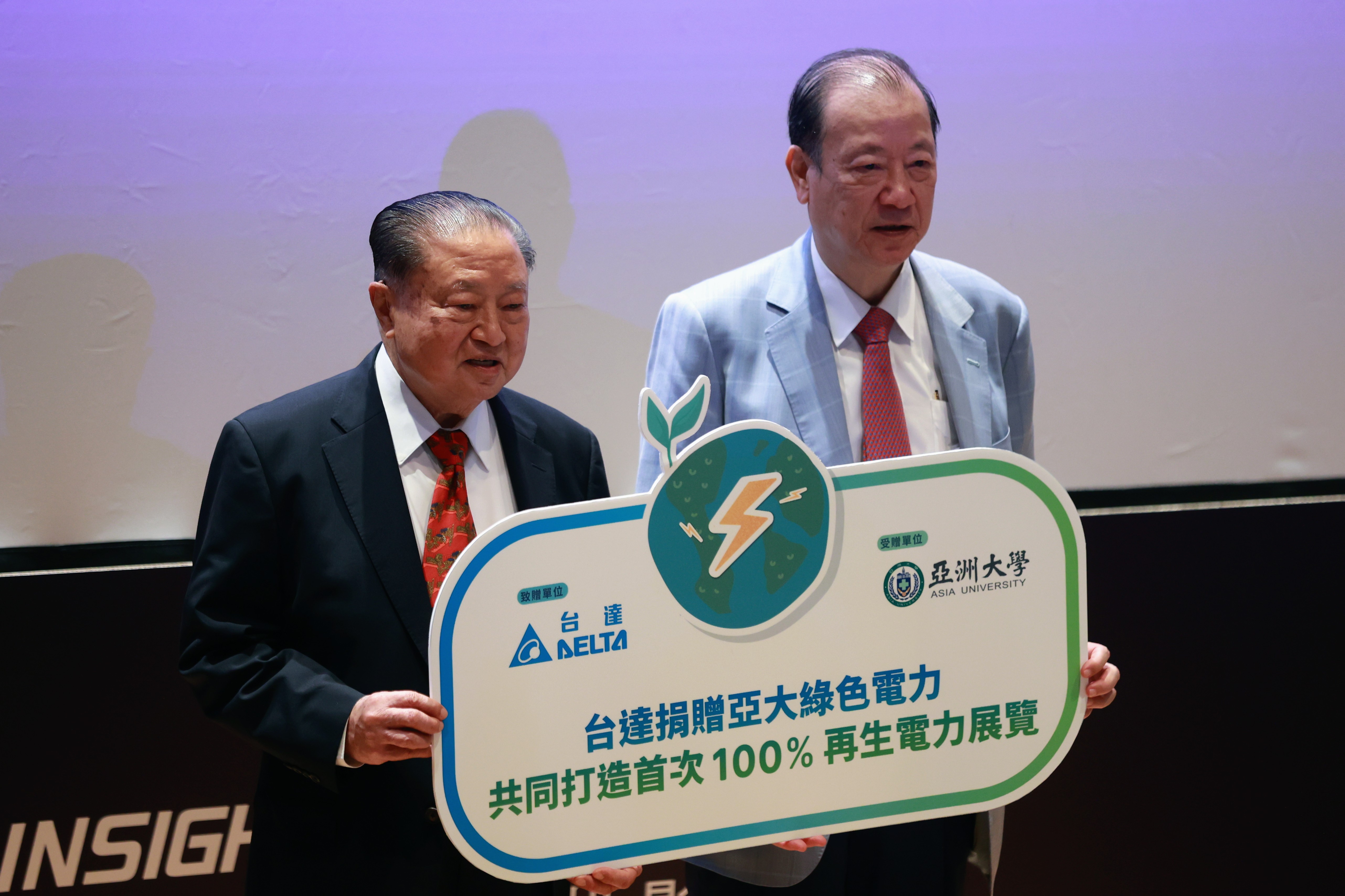 鄭崇華（左）呼籲國人重視氣候變遷，帶來100％使用再生電力的展覽。