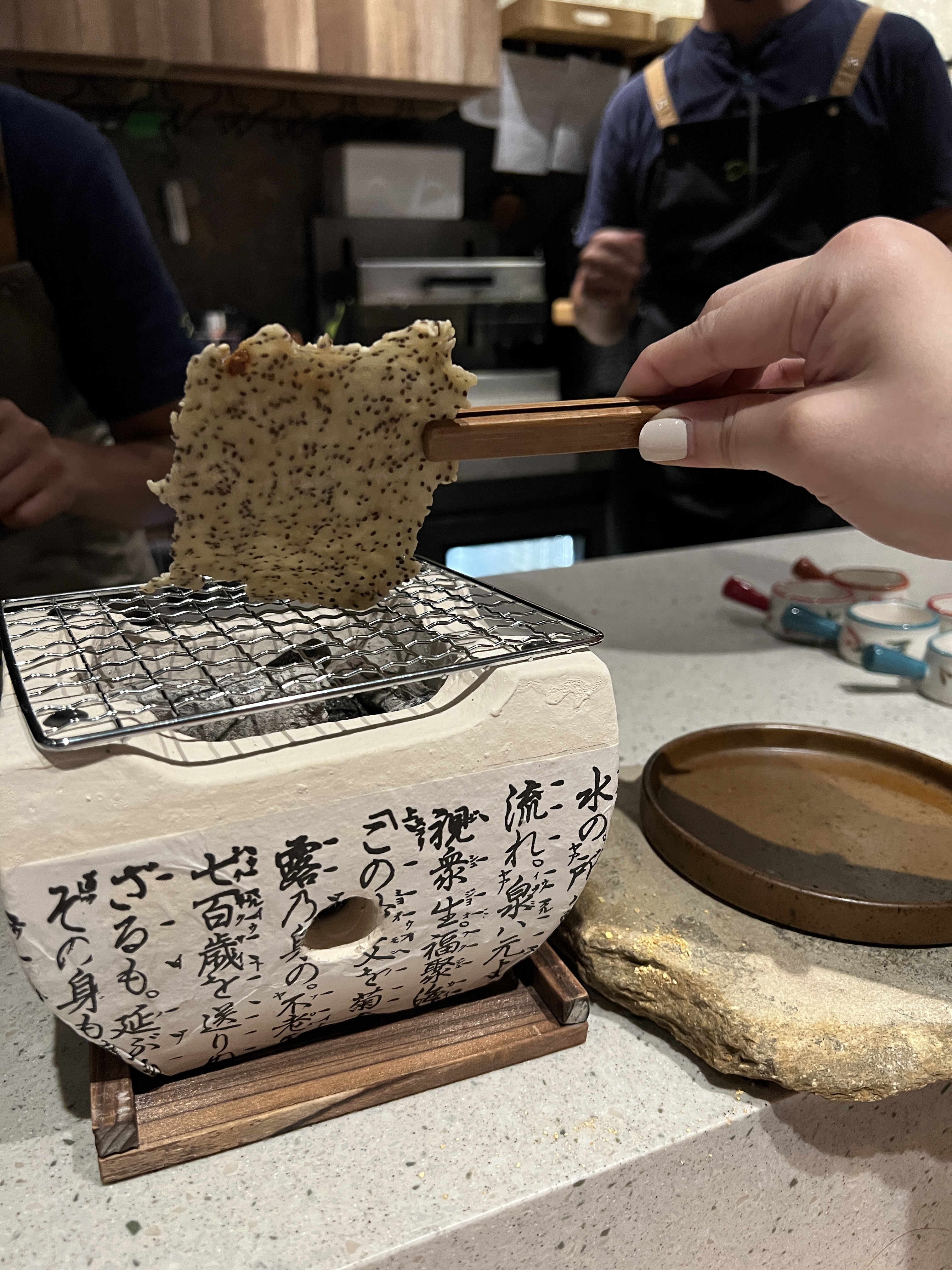 上某一道菜時（這裡不劇透），會在每位桌前放一個烤爐，讓你把餐廳自製的酸種麵糰烤餅烤熟。