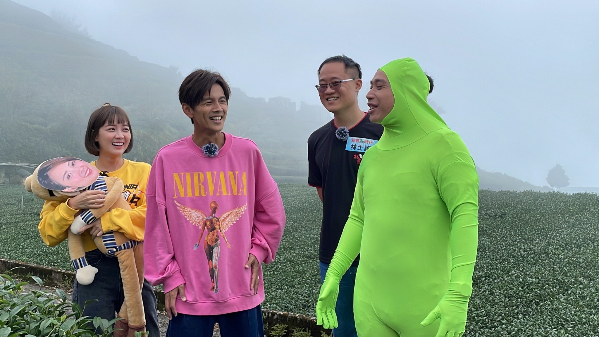 無尊穿著「綠色緊身衣」出現在茶園,還要詮釋不發笑(發酵),不管浩翔如何搔癢都不笑,超無厘畫面逗樂職人。(民視提供)