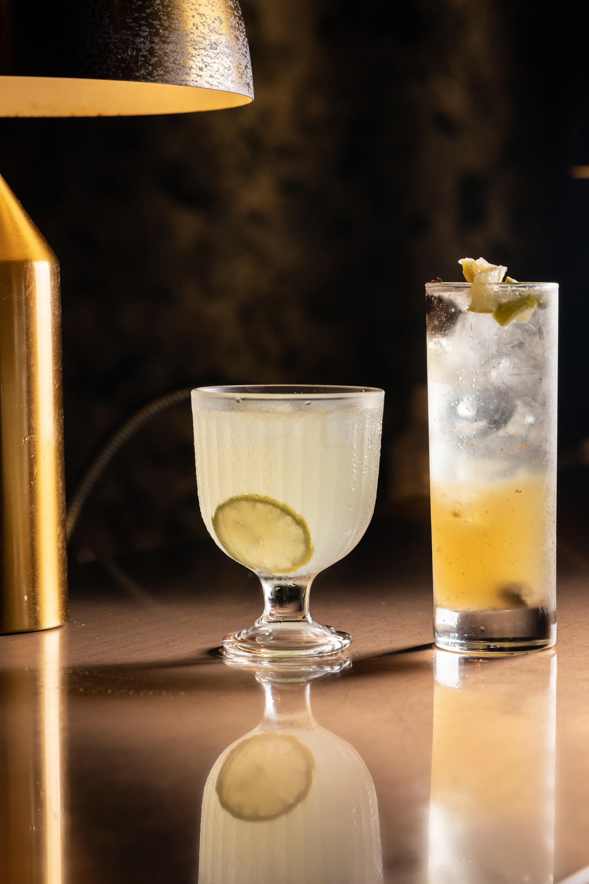 「荔枝酸酒」（左，260元／杯）以荔枝酒搭配伏特加；「老闆娘特調」（右，350元／杯）則以長島冰茶與環遊世界為概念，加入台灣人熟悉的居家調酒梅子高粱，是一杯酒感重的雞尾酒。