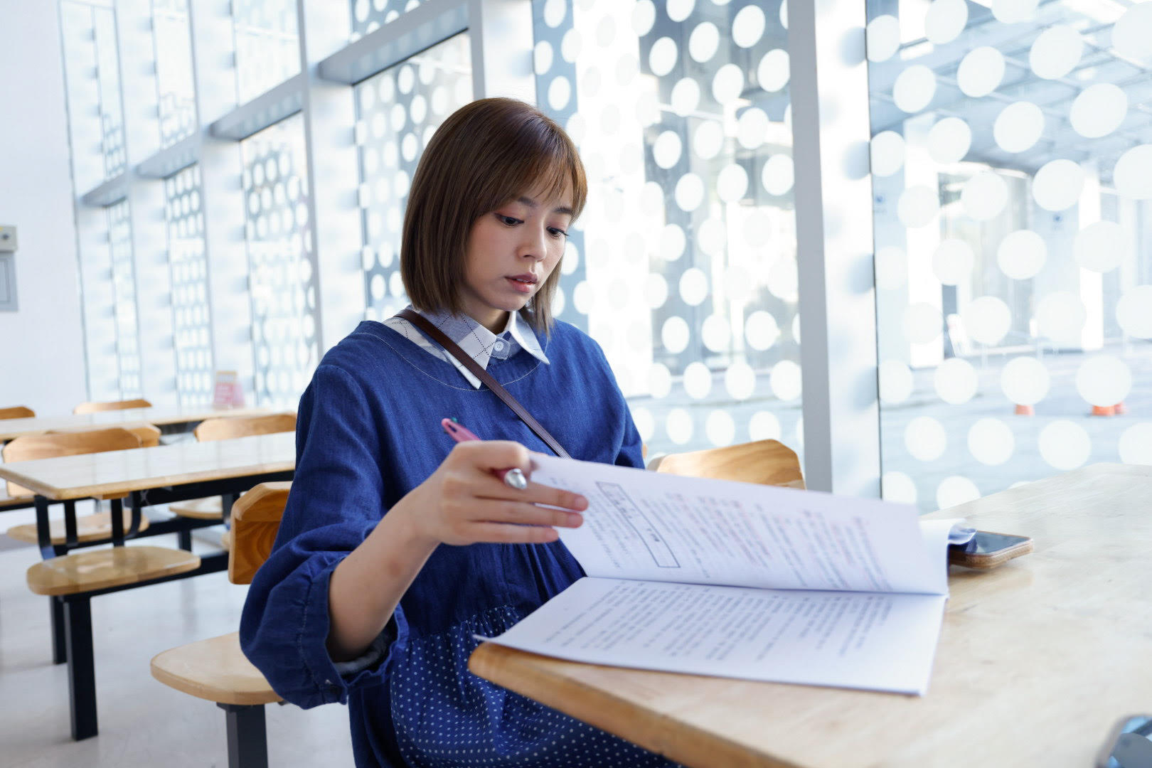 王瞳為八點檔《市井豪門》穿孕婦裝在做劇本功課。（民視提供）