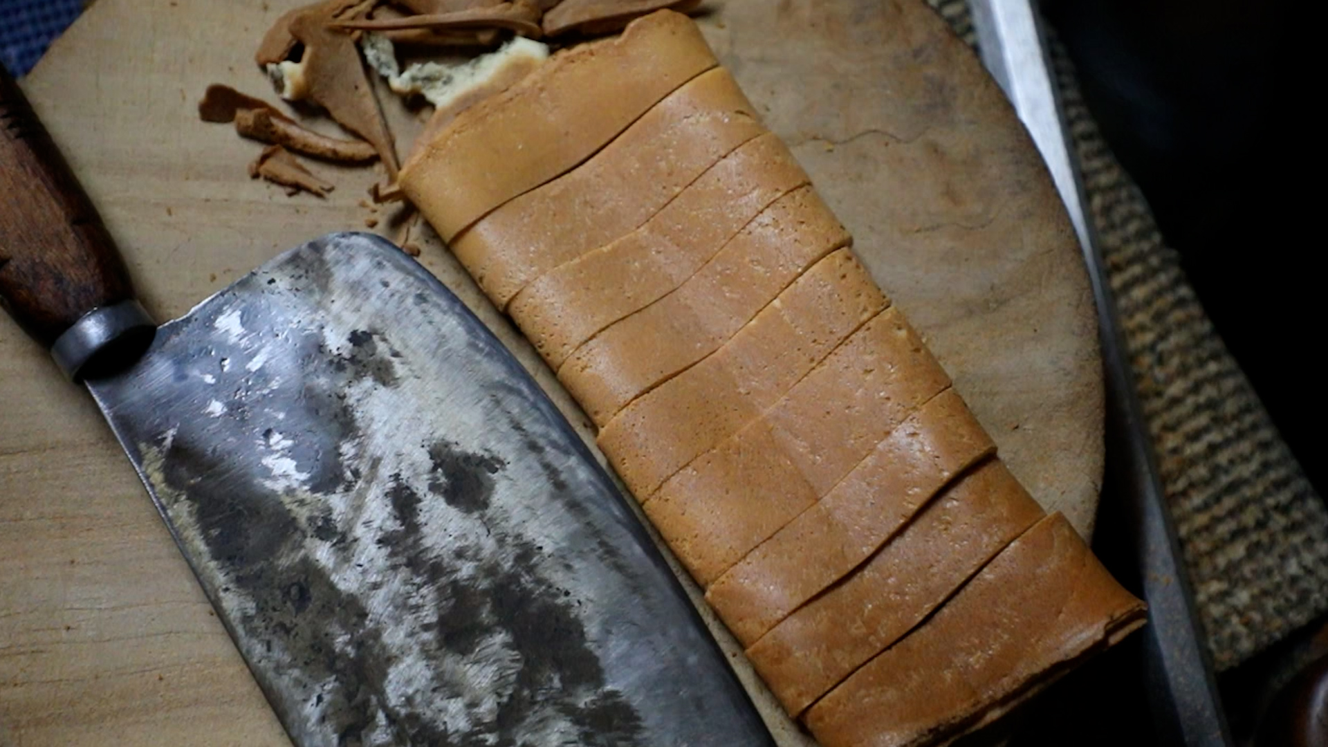 「味噌煎餅」煎熟之後要捲起來，用鋼條壓著定型，再切成小塊。