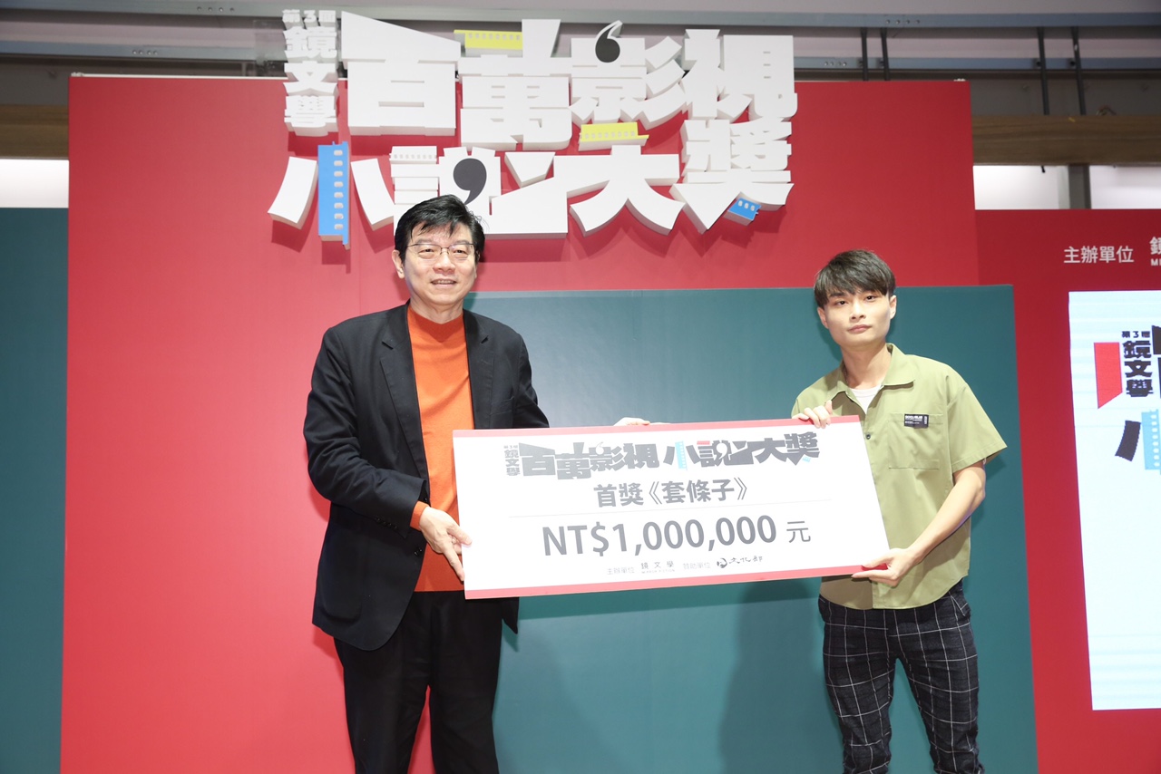 鏡文學董事長裴偉（左）頒發影視百萬首獎給得獎者顏瑜。