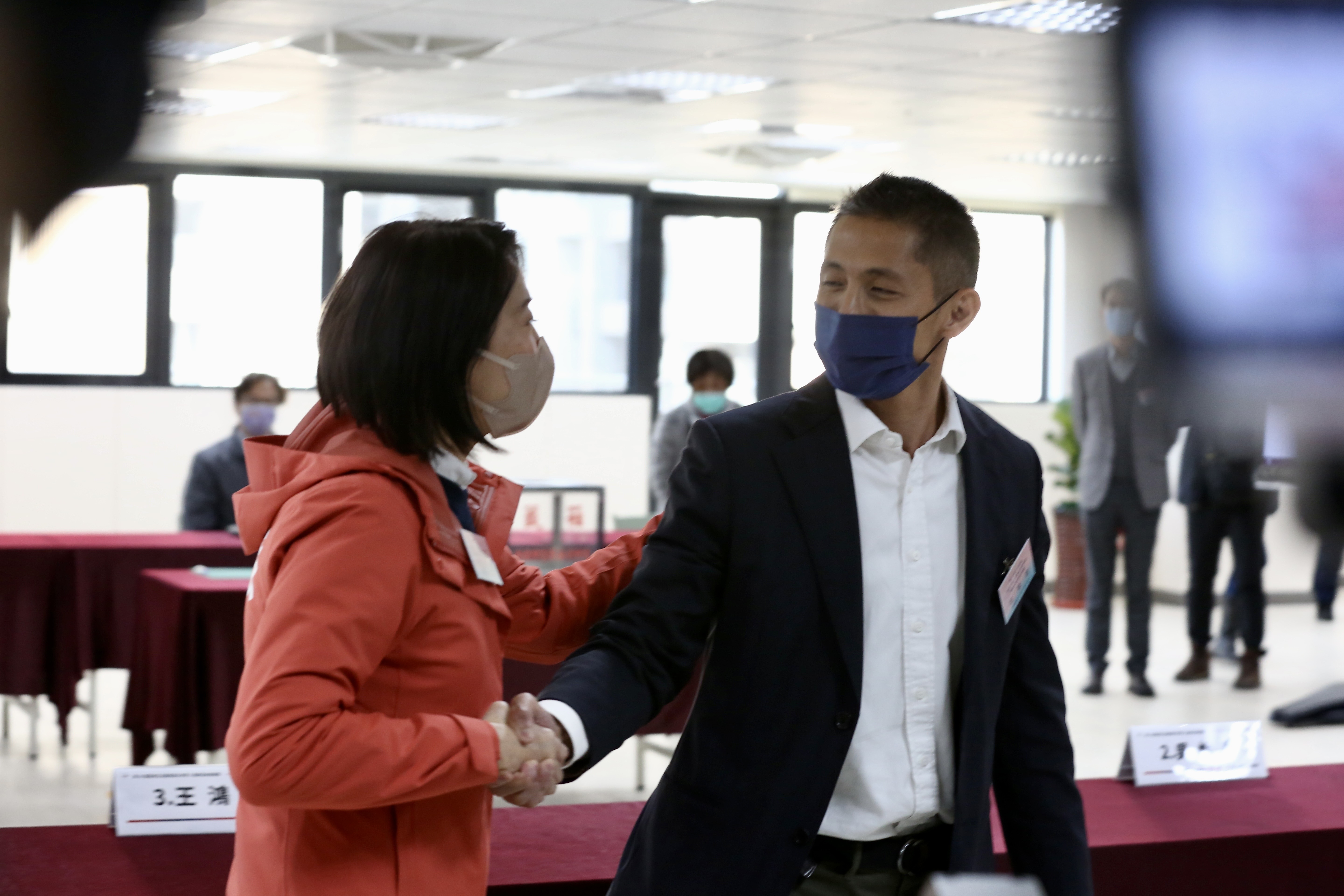 王鴻薇（左）今在號次抽籤時與吳怡農（右）握手致意。