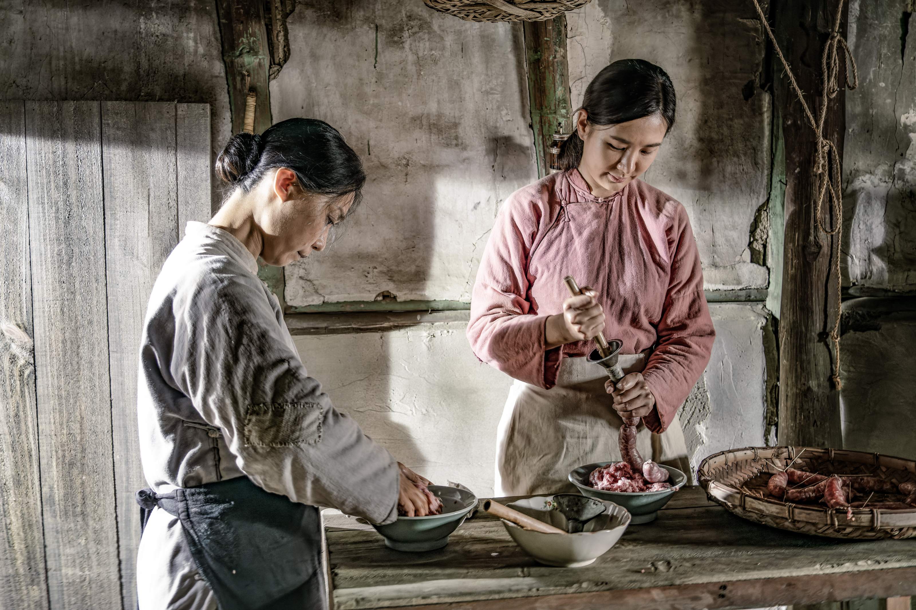 《牛車來去》劇中貧農安心亞、黃婕菲私宰豬肉並灌香腸保存橋段創下收視高點 ，也讓網友讚嘆看見古早時期的生活技巧。（公視提供）