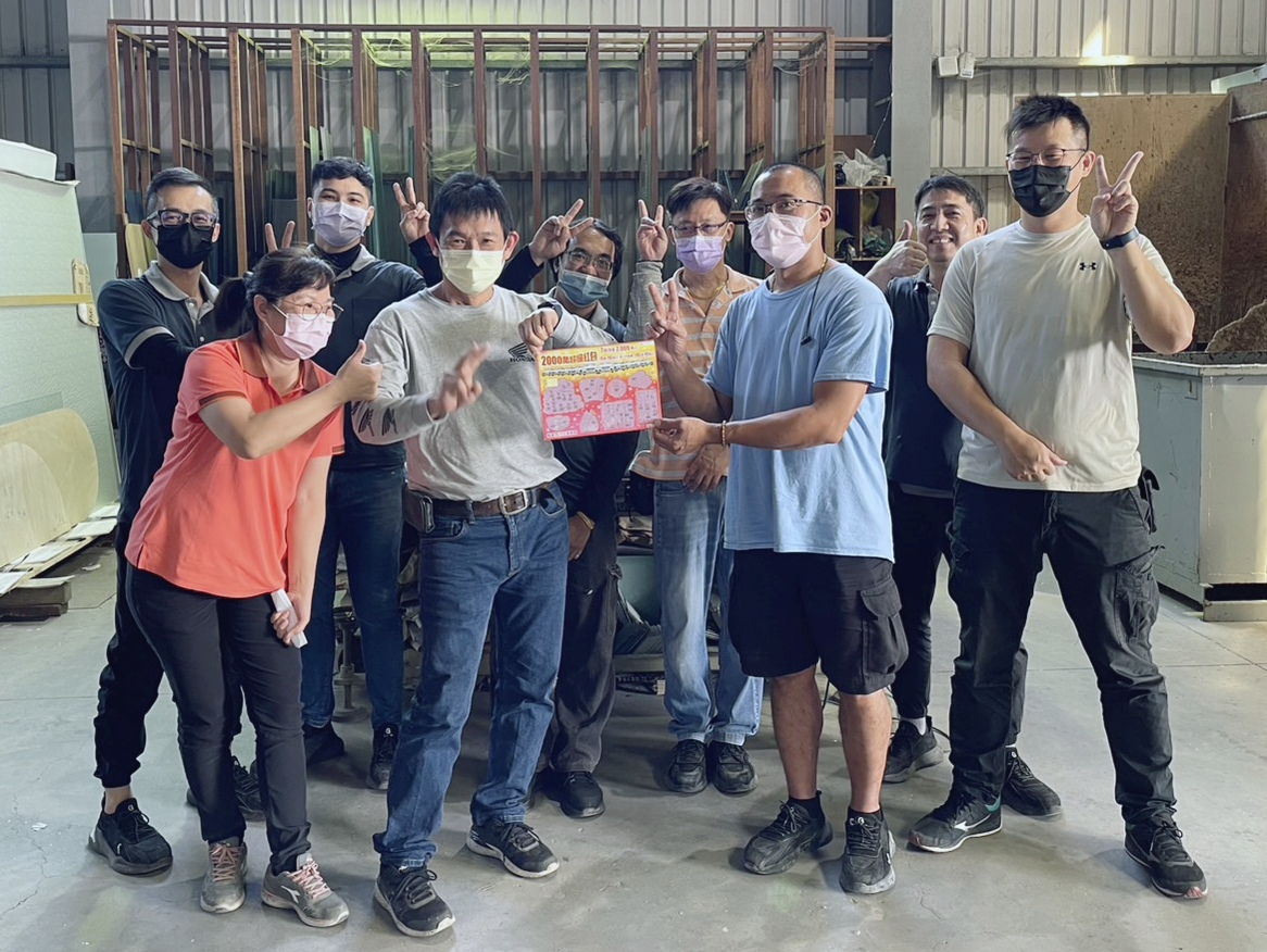 高雄一家小公司10員工集資購買2000萬元獎項的刮刮樂，一名超幸運的林姓員工（平頭藍衣者），連續2年刮中100萬元。（翻攝畫面）