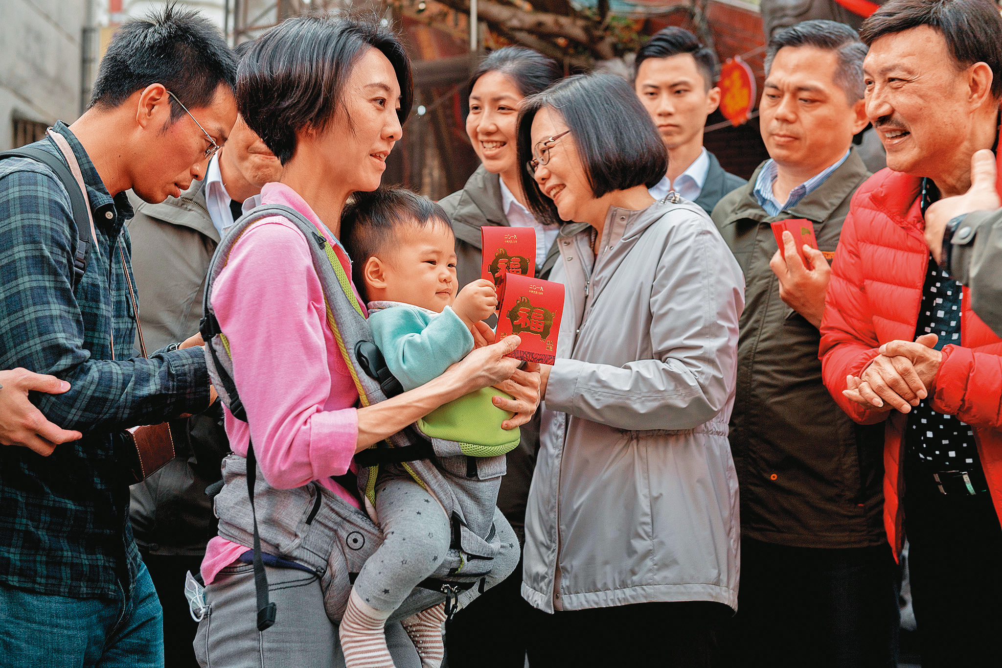 受疫情影響，蔡英文牛年、虎年春節都未到廟宇發紅包。圖為2019年春節蔡發紅包給民眾。（總統府提供）