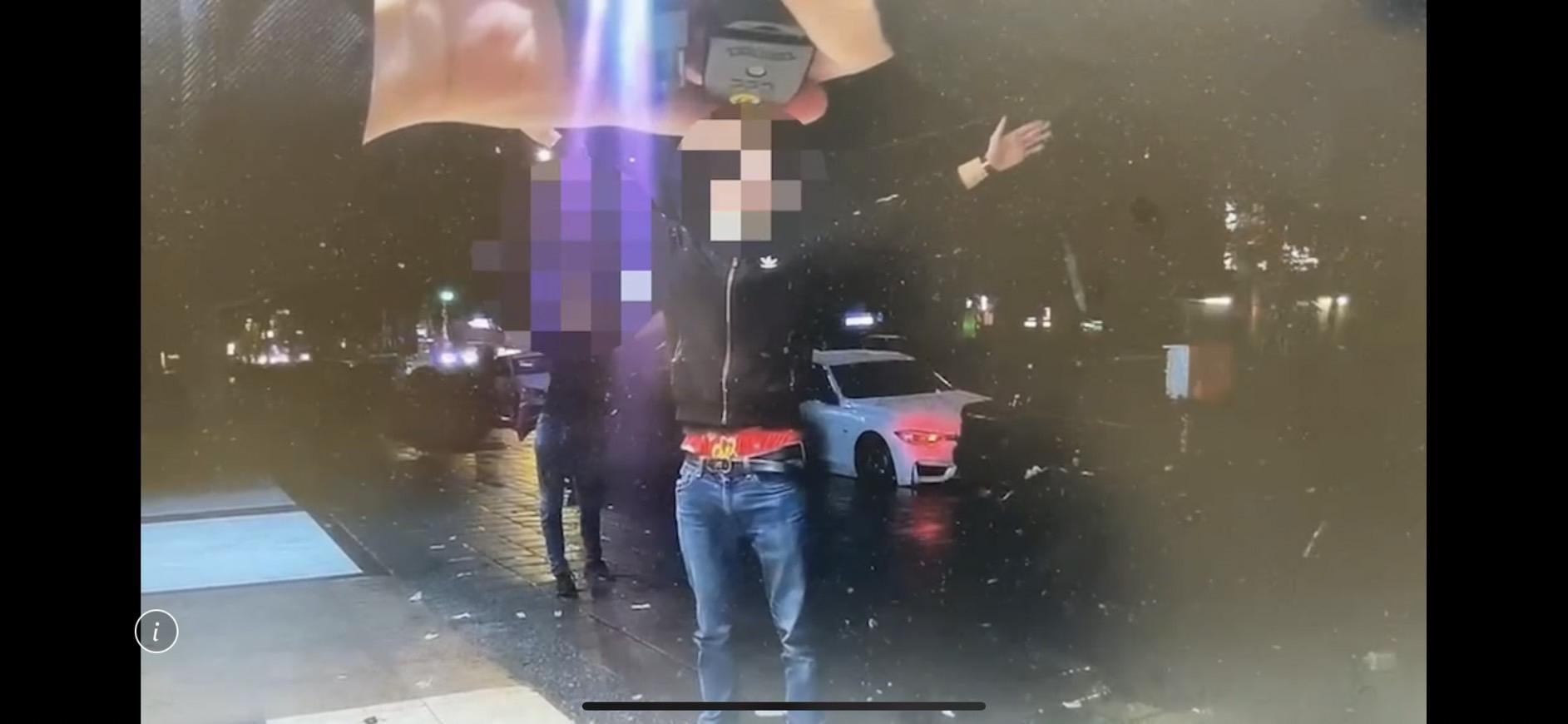 朱男借到手槍隨即被警方在騎樓攔查，高舉雙手。（翻攝畫面）