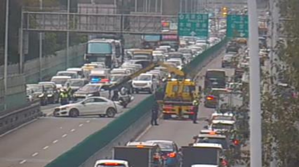 建國高架發生3車連撞事故，多名員警緊急到場支援，也找來輛吊車協助拖吊。（翻攝自即時影像監視器）