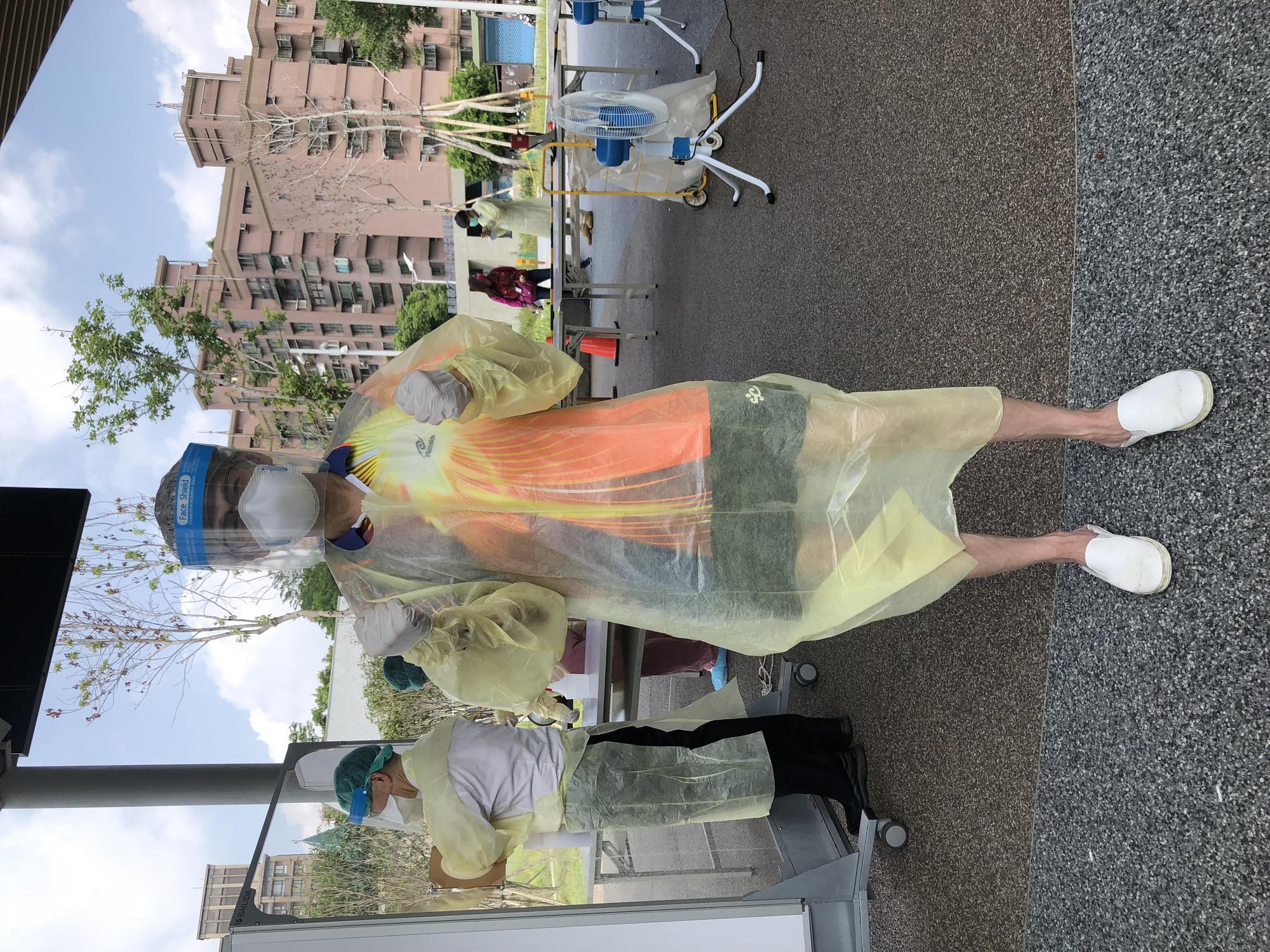 去年5月篩檢站的醫護人員頂著高溫,替民眾篩檢。(周慶明提供)
