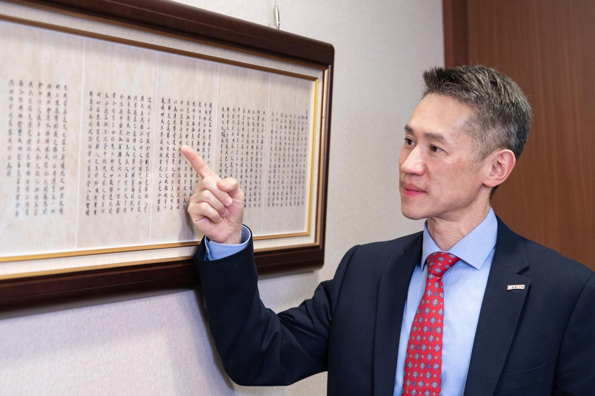 清華大學校長高為元端詳以庚子賠款退款建校的珍貴歷史文件。(清華大學提供)