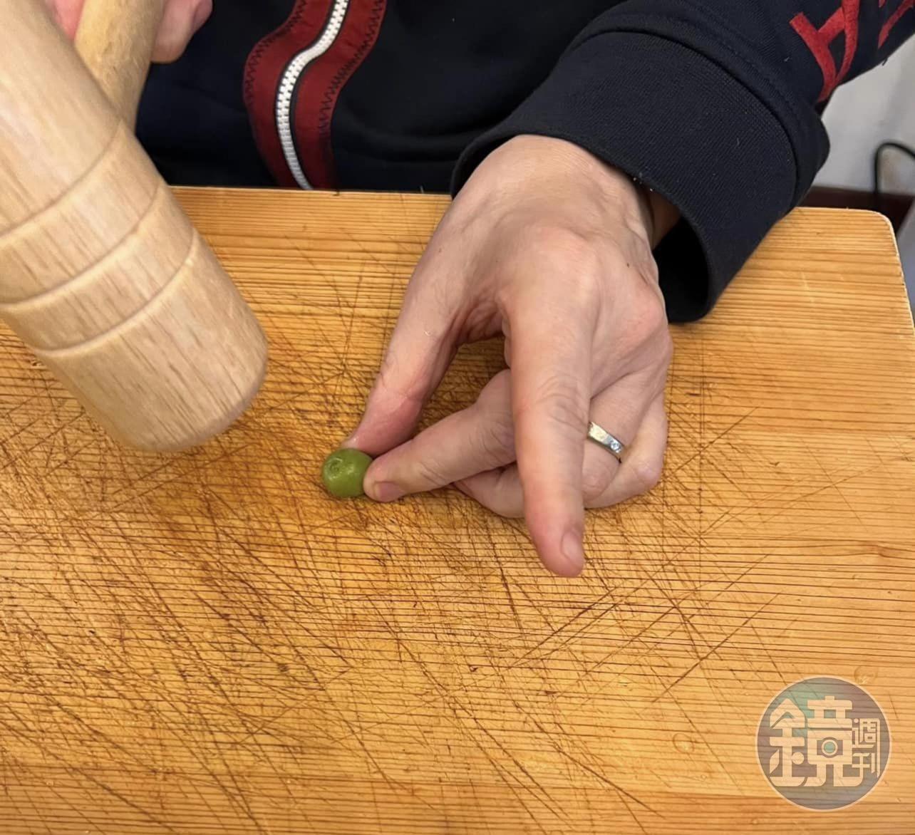 敲破梅子，用木槌將去青後的梅子從蒂頭部分敲下，讓果肉裂開。結果大家都只看到蓮花指。