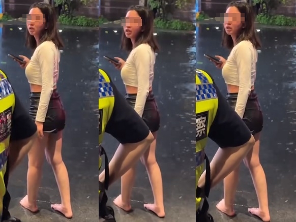 白衣女遭熱湯燙傷後，面對警方的問題仍能如流回應，但仔細看，女子的臉部已明顯紅腫，疑似起水泡。（翻攝自爆廢公社）