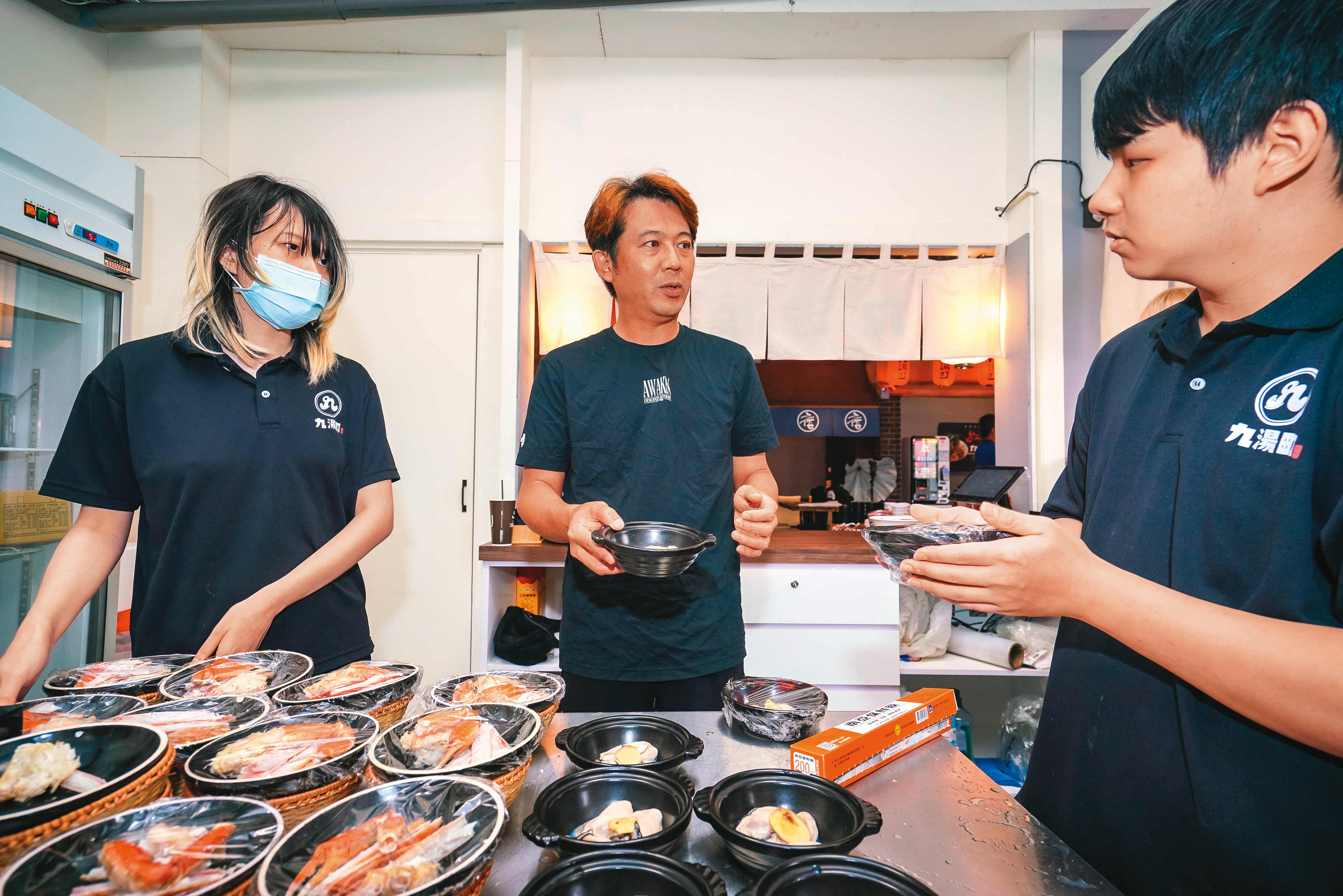 因應用餐時間人潮，翁暐鈞（中）會請員工把熱門產品的配料先抓出來，再把每一碗醬料都預先秤好，以加快出餐速度。