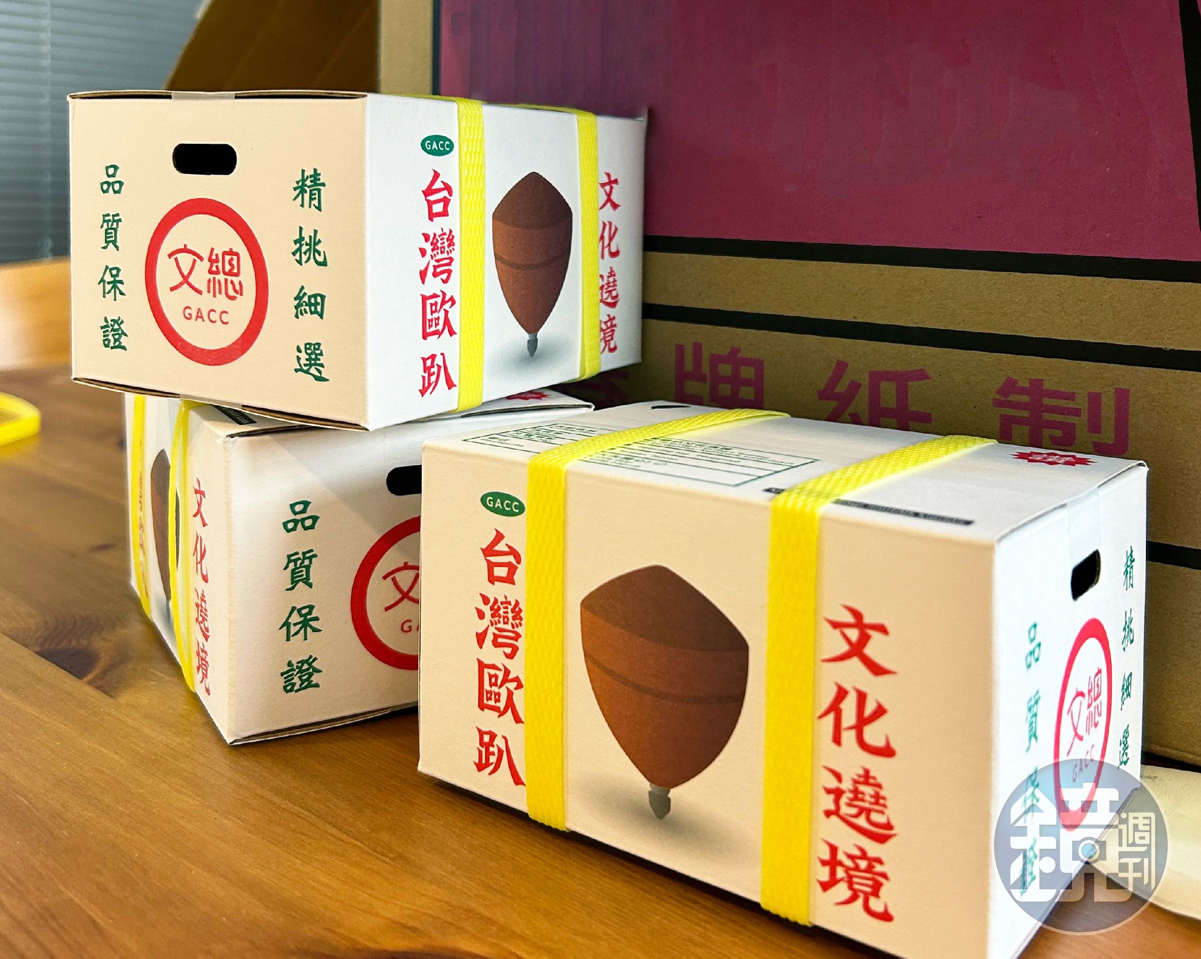 以台灣常見的紅白配色水果箱，作為陀螺的外包裝，配上黃色封箱繩與產品標示等設計，充滿濃濃台味。（文化總會提供）
